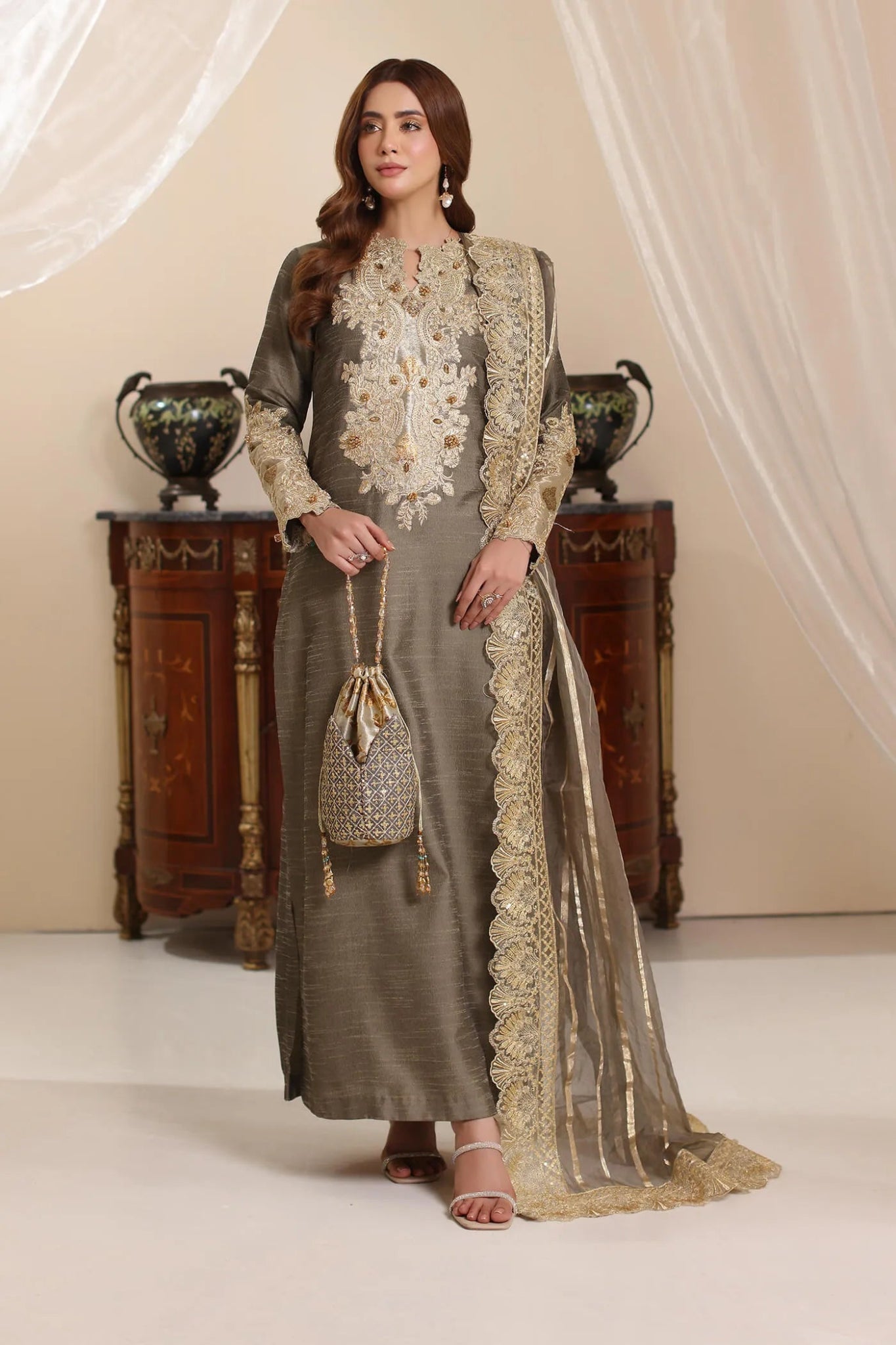 Model wearing Musferah Saad Olive Taupe dress from the Amor a La Vida collection in olive with golden lace detailing, ideal for Pakistani wedding clothes online in the UK.