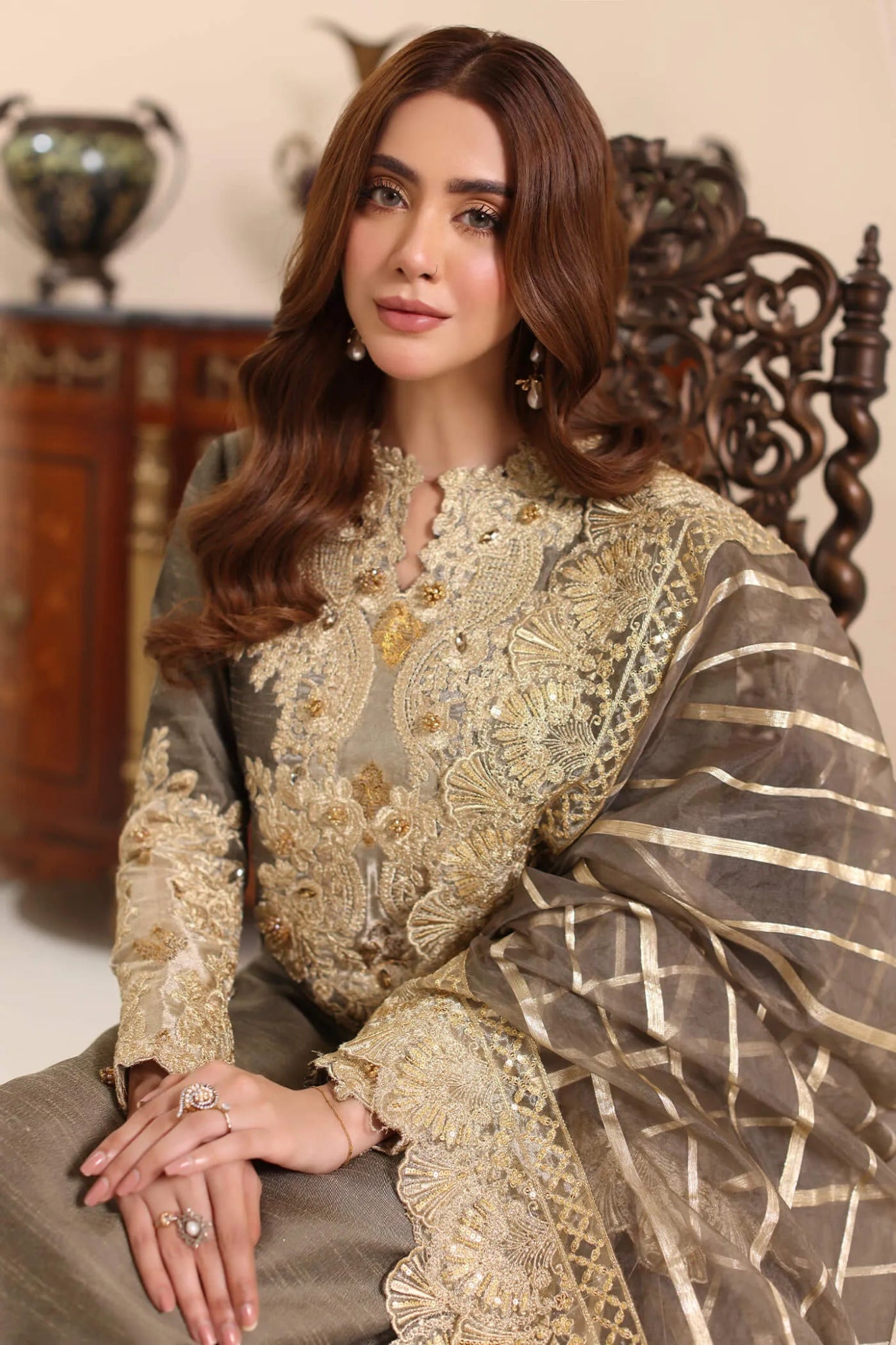 Model wearing Musferah Saad Olive Taupe dress from the Amor a La Vida collection in olive with golden lace detailing, ideal for Pakistani wedding clothes online in the UK.