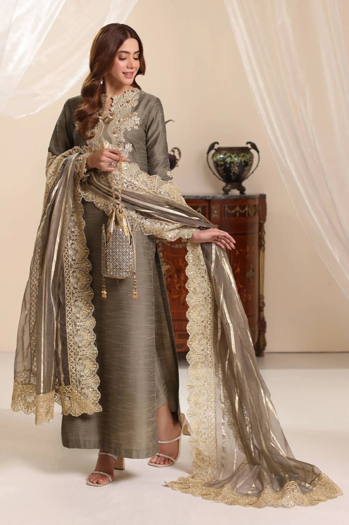 Model wearing Musferah Saad Olive Taupe dress from the Amor a La Vida collection in olive with golden lace detailing, ideal for Pakistani wedding clothes online in the UK.