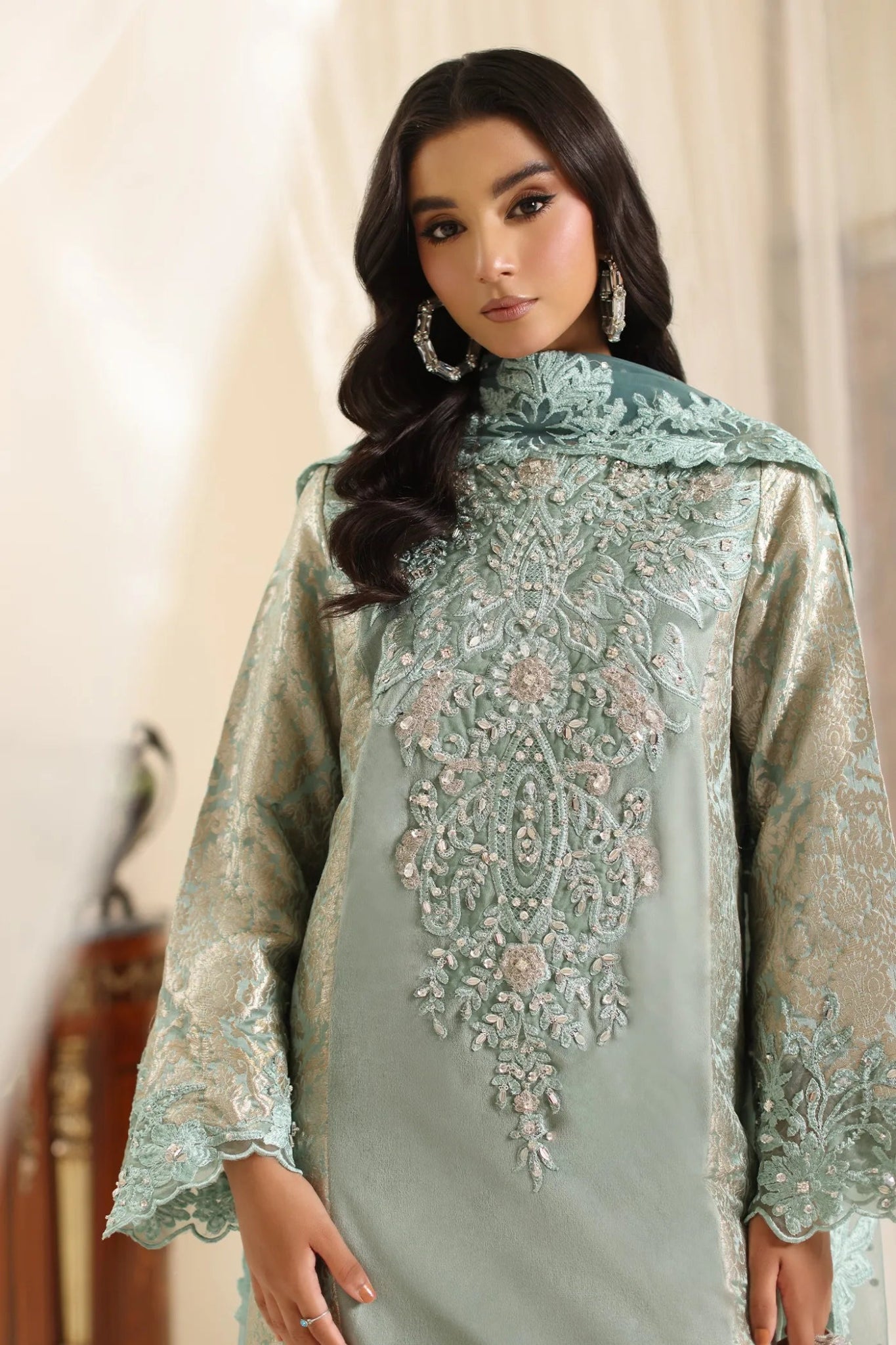 Model wearing Musferah Saad Sage Queen dress from the Amor a La Vida collection in light sage with intricate embroidery, perfect for Pakistani wedding clothes online in the UK.