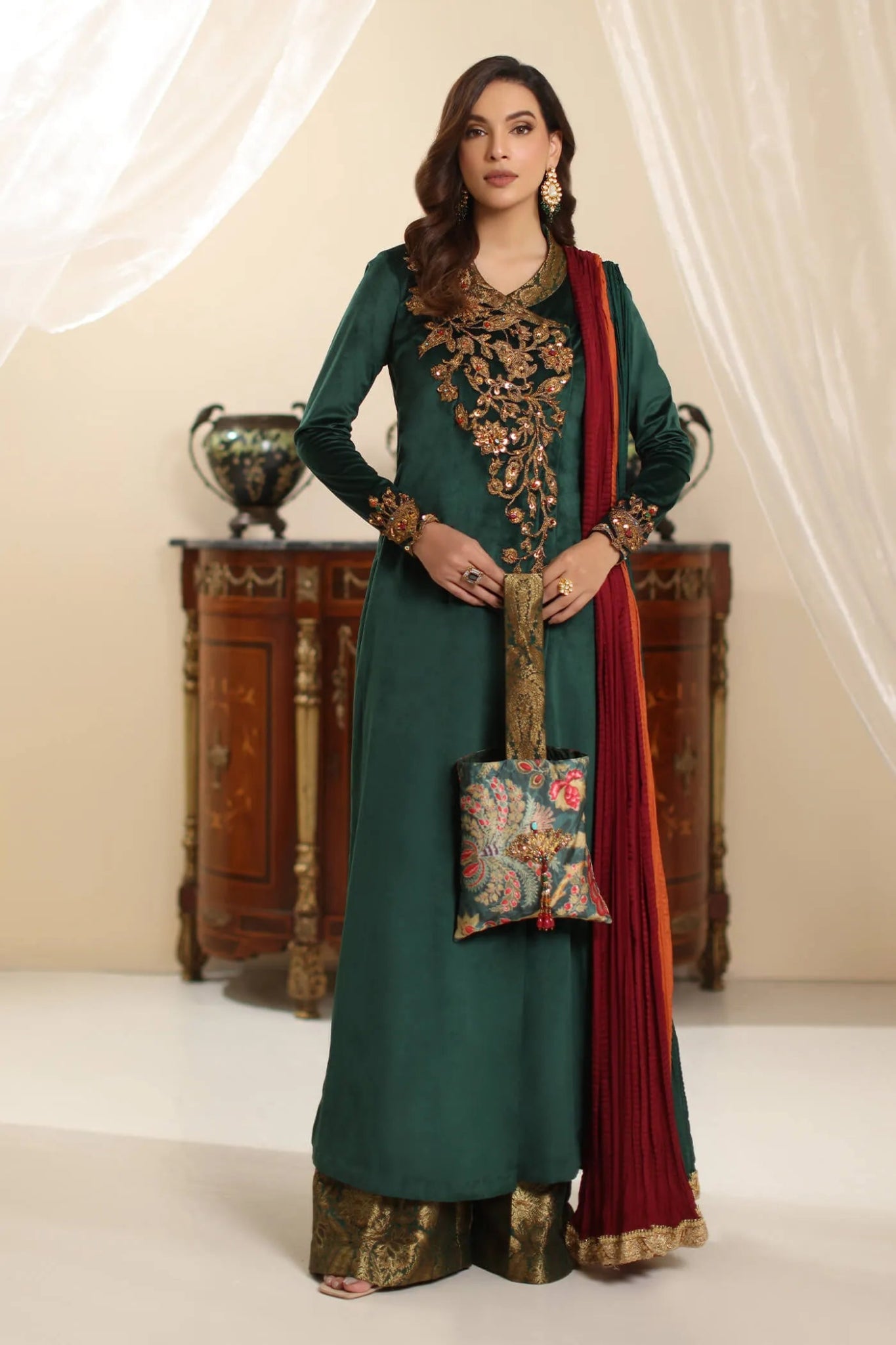 Model wearing Musferah Saad Serene Opulence dress from the Amor a La Vida collection in deep green with intricate gold embellishments, ideal for Pakistani wedding clothes online in the UK.