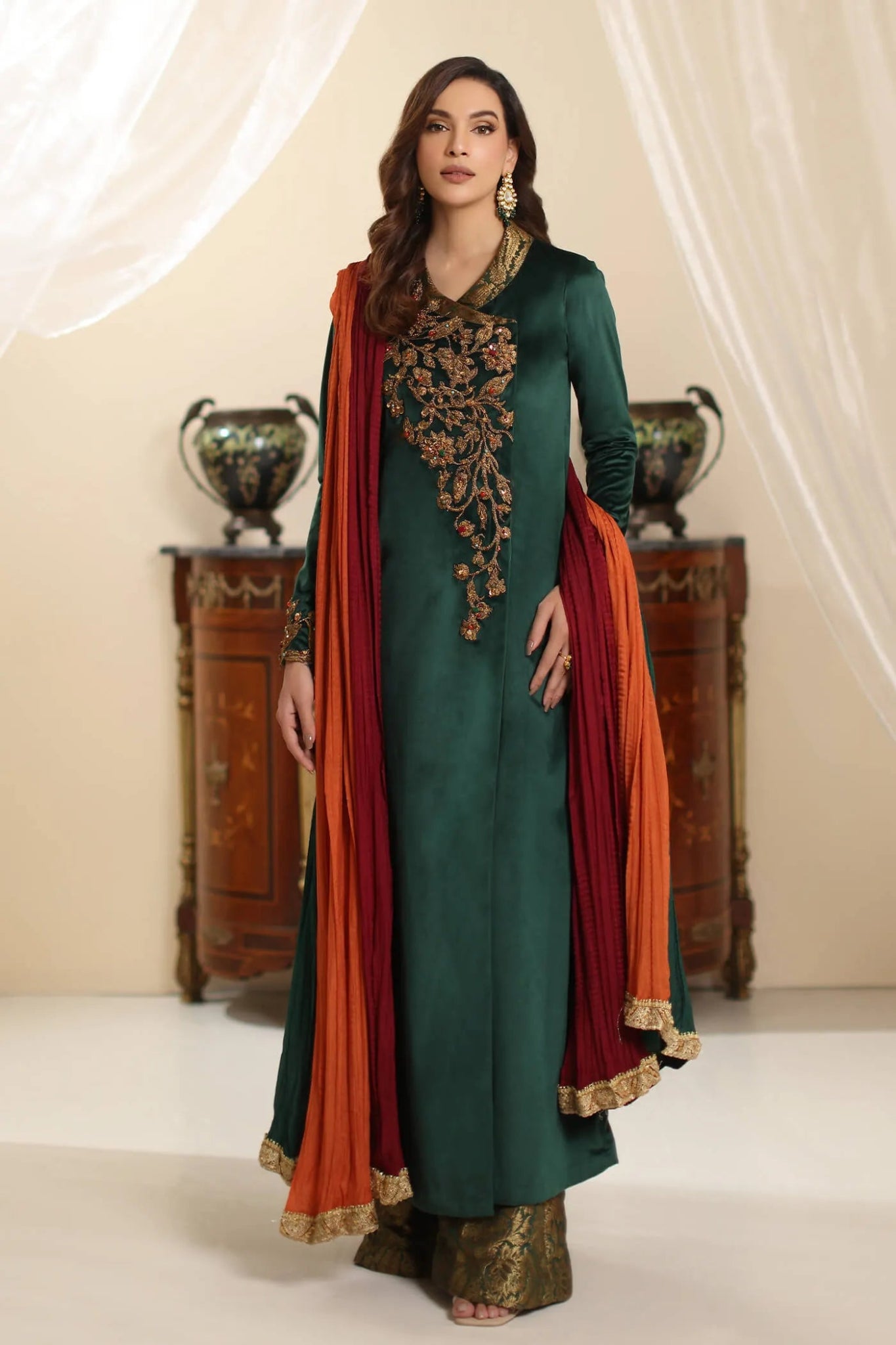 Model wearing Musferah Saad Serene Opulence dress from the Amor a La Vida collection in deep green with intricate gold embellishments, ideal for Pakistani wedding clothes online in the UK.