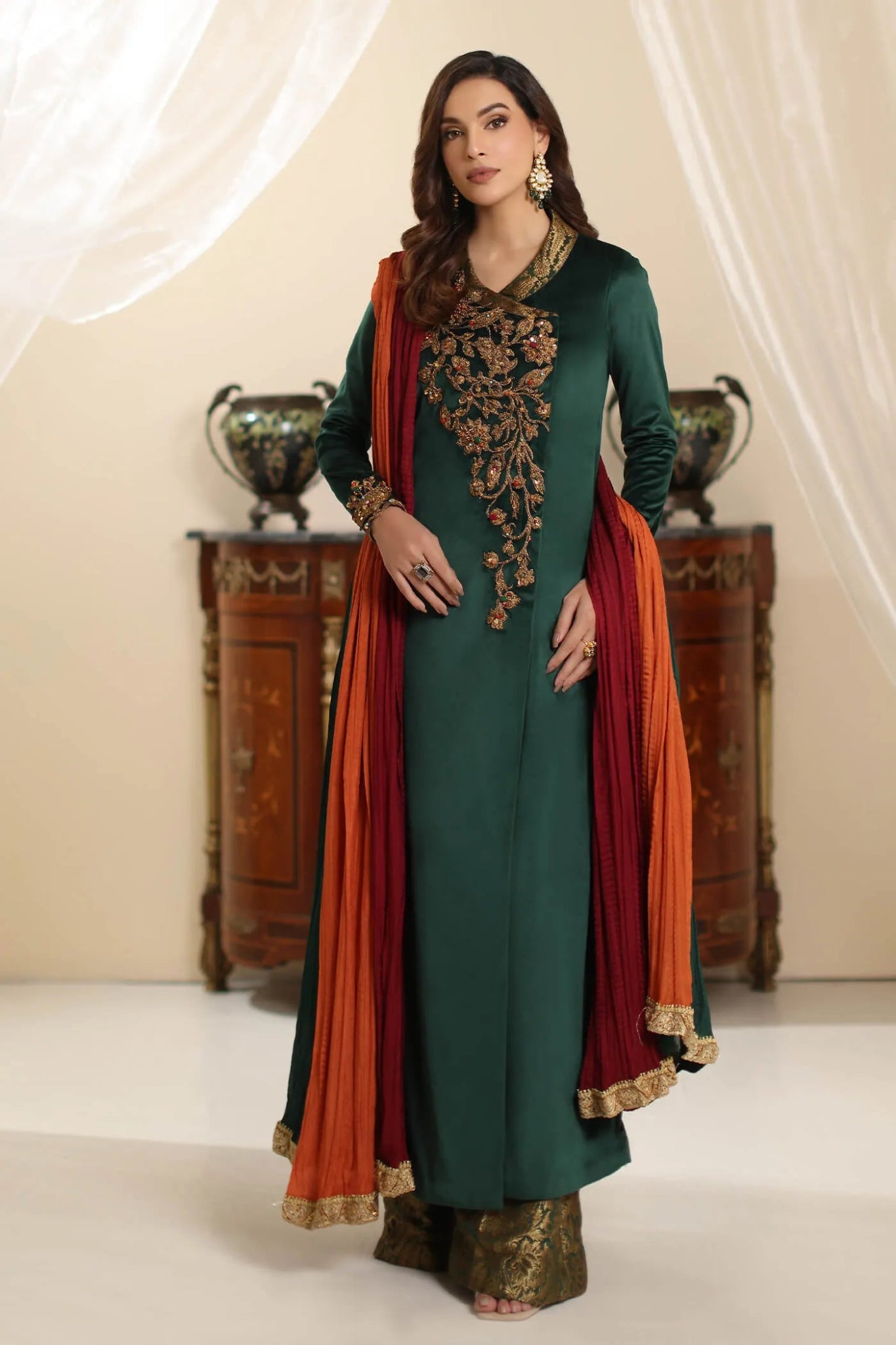 Model wearing Musferah Saad Serene Opulence dress from the Amor a La Vida collection in deep green with intricate gold embellishments, ideal for Pakistani wedding clothes online in the UK.