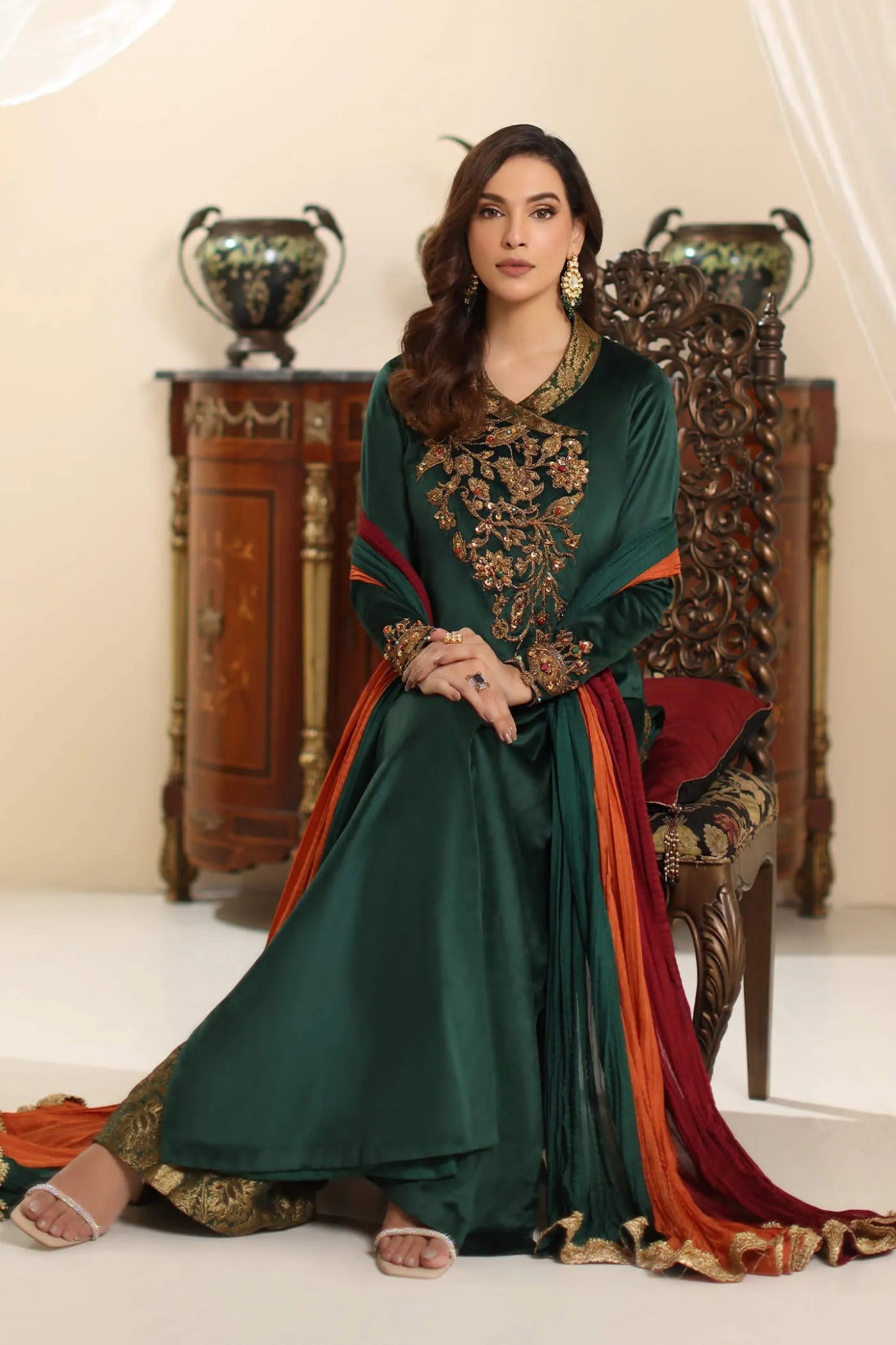 Model wearing Musferah Saad Serene Opulence dress from the Amor a La Vida collection in deep green with intricate gold embellishments, ideal for Pakistani wedding clothes online in the UK.