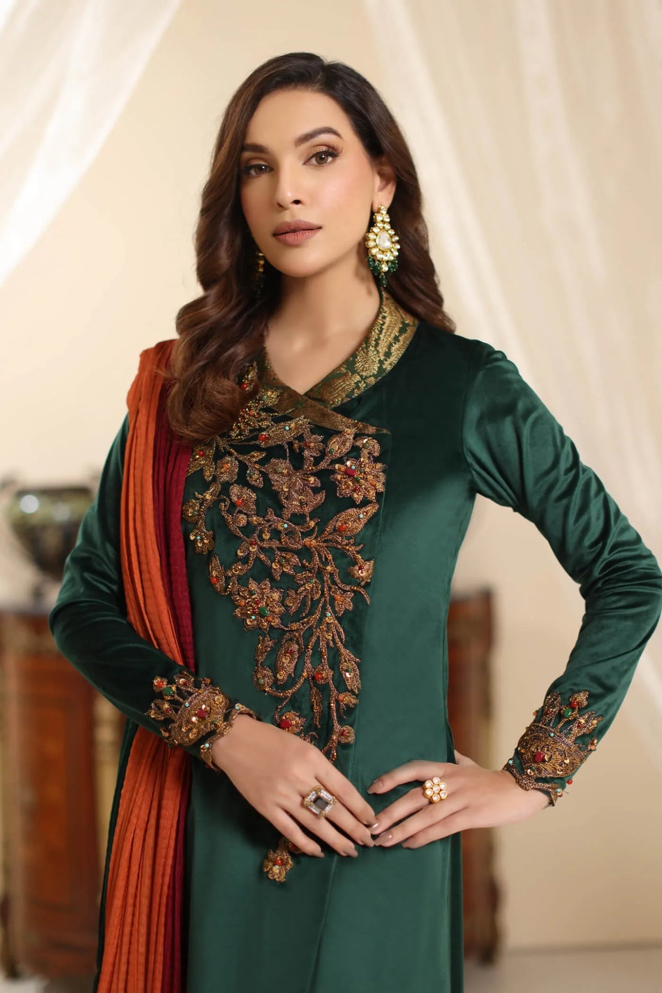 Model wearing Musferah Saad Serene Opulence dress from the Amor a La Vida collection in deep green with intricate gold embellishments, ideal for Pakistani wedding clothes online in the UK.