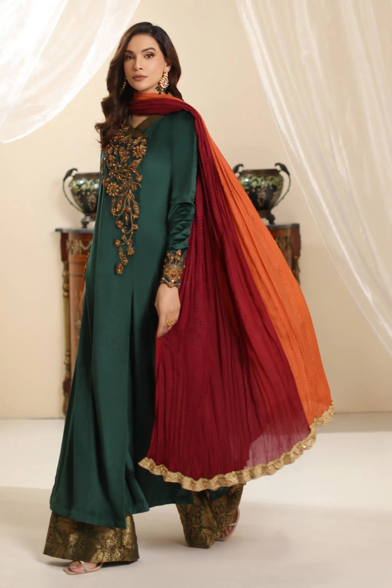 Model wearing Musferah Saad Serene Opulence dress from the Amor a La Vida collection in deep green with intricate gold embellishments, ideal for Pakistani wedding clothes online in the UK.