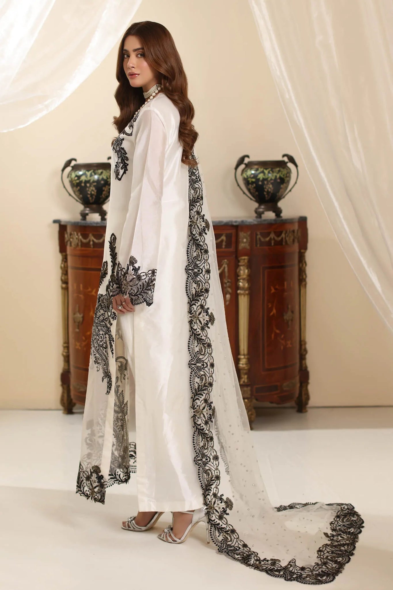 Model wearing Musferah Saad Whisper Noir dress from the Amor a La Vida collection in white with black embroidery, perfect for Pakistani wedding clothes online in the UK.