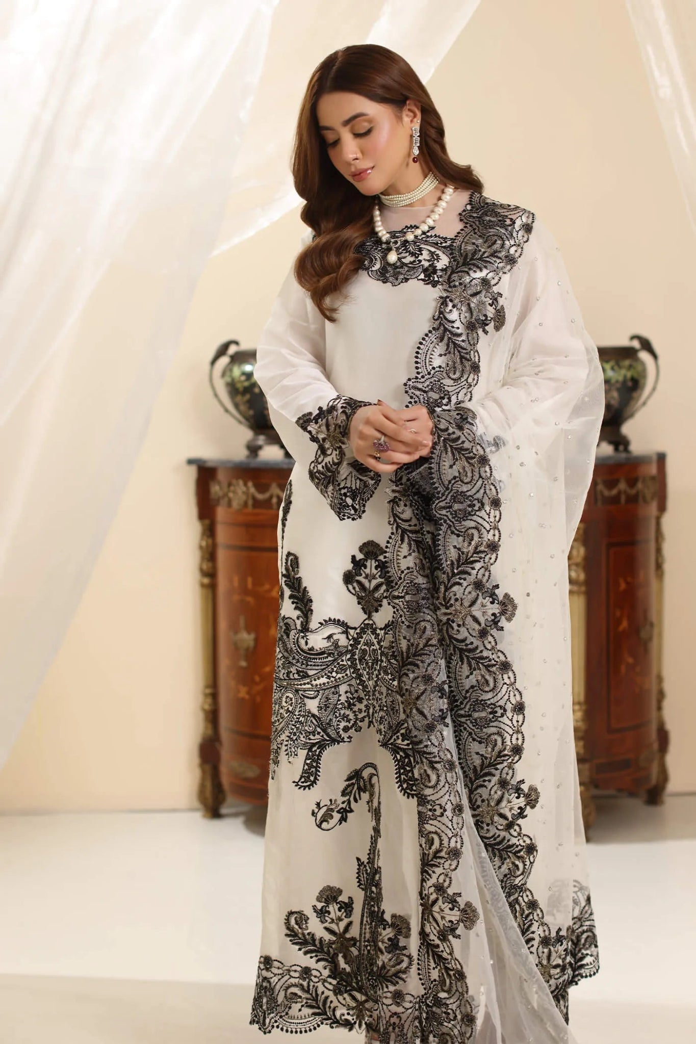 Model wearing Musferah Saad Whisper Noir dress from the Amor a La Vida collection in white with black embroidery, perfect for Pakistani wedding clothes online in the UK.