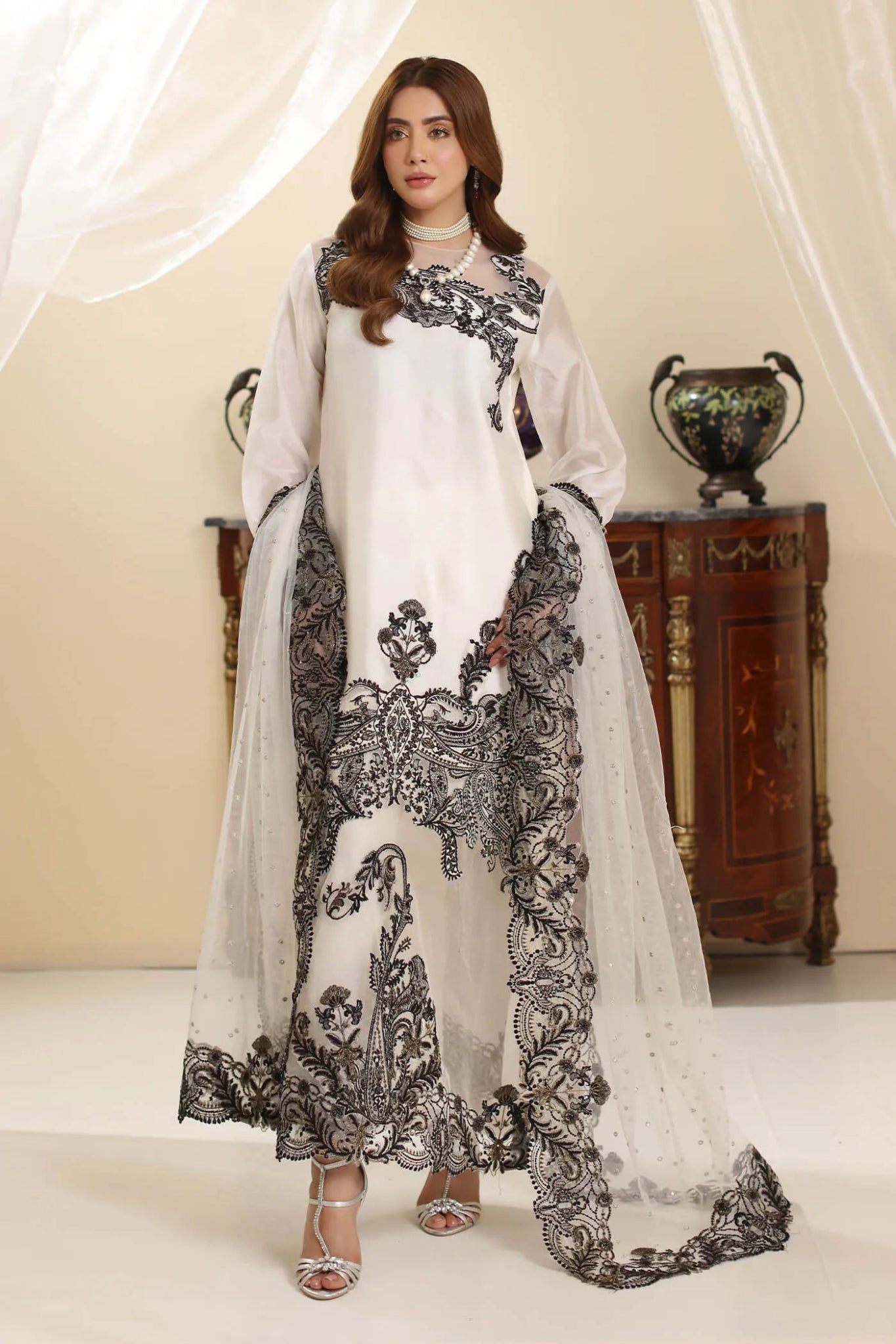 Model wearing Musferah Saad Whisper Noir dress from the Amor a La Vida collection in white with black embroidery, perfect for Pakistani wedding clothes online in the UK.