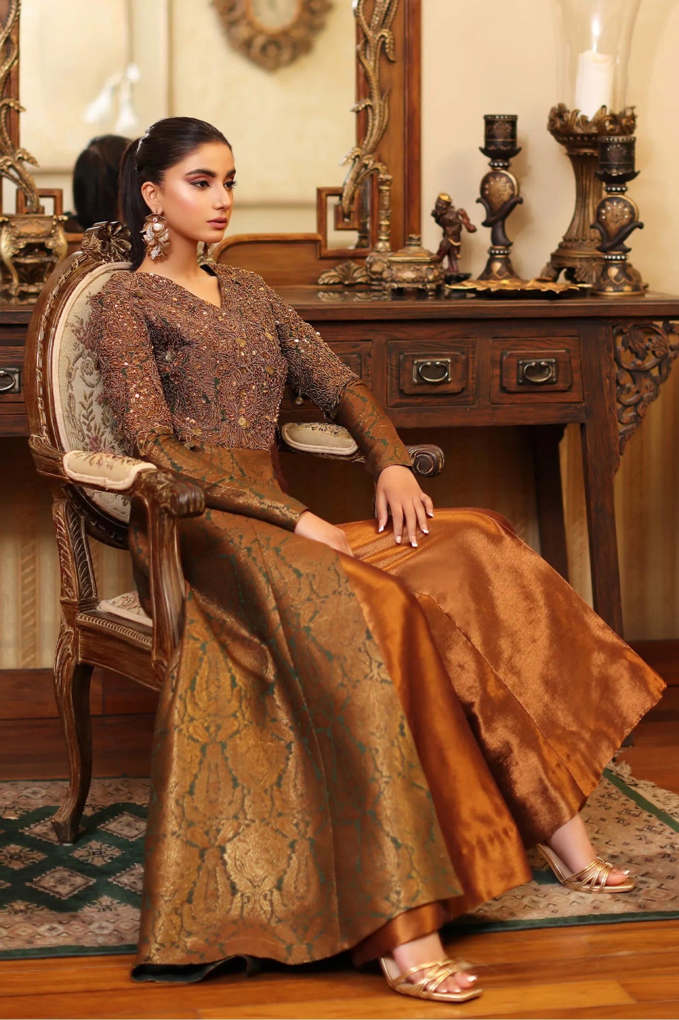 Model wearing a bronze and gold ENCHANTED MAJESTY dress from Musferah Saad's ENCHANTE Eid collection '24, showcasing Pakistani clothes online in the UK.