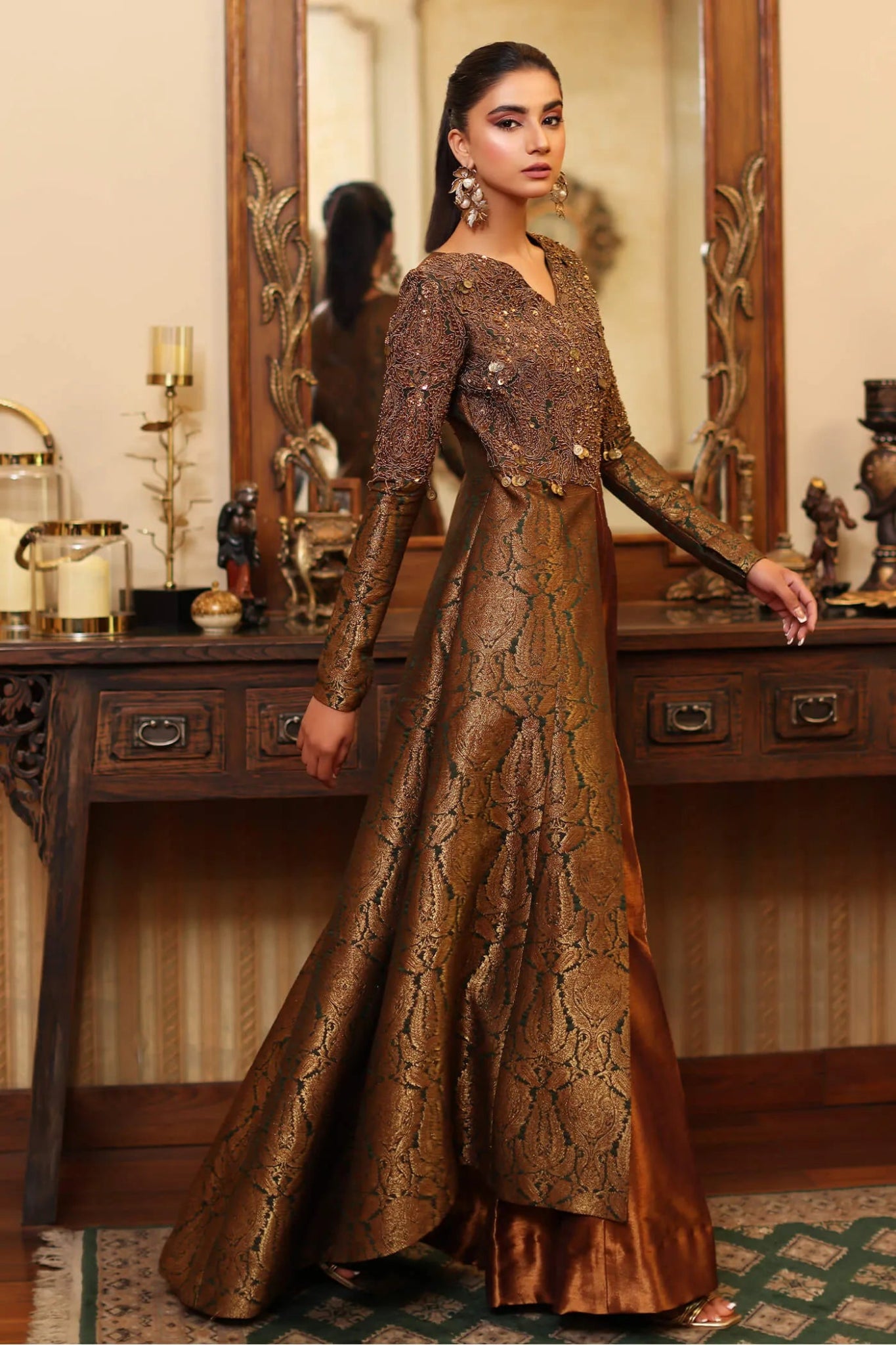 Model wearing a bronze and gold ENCHANTED MAJESTY dress from Musferah Saad's ENCHANTE Eid collection '24, showcasing Pakistani clothes online in the UK.