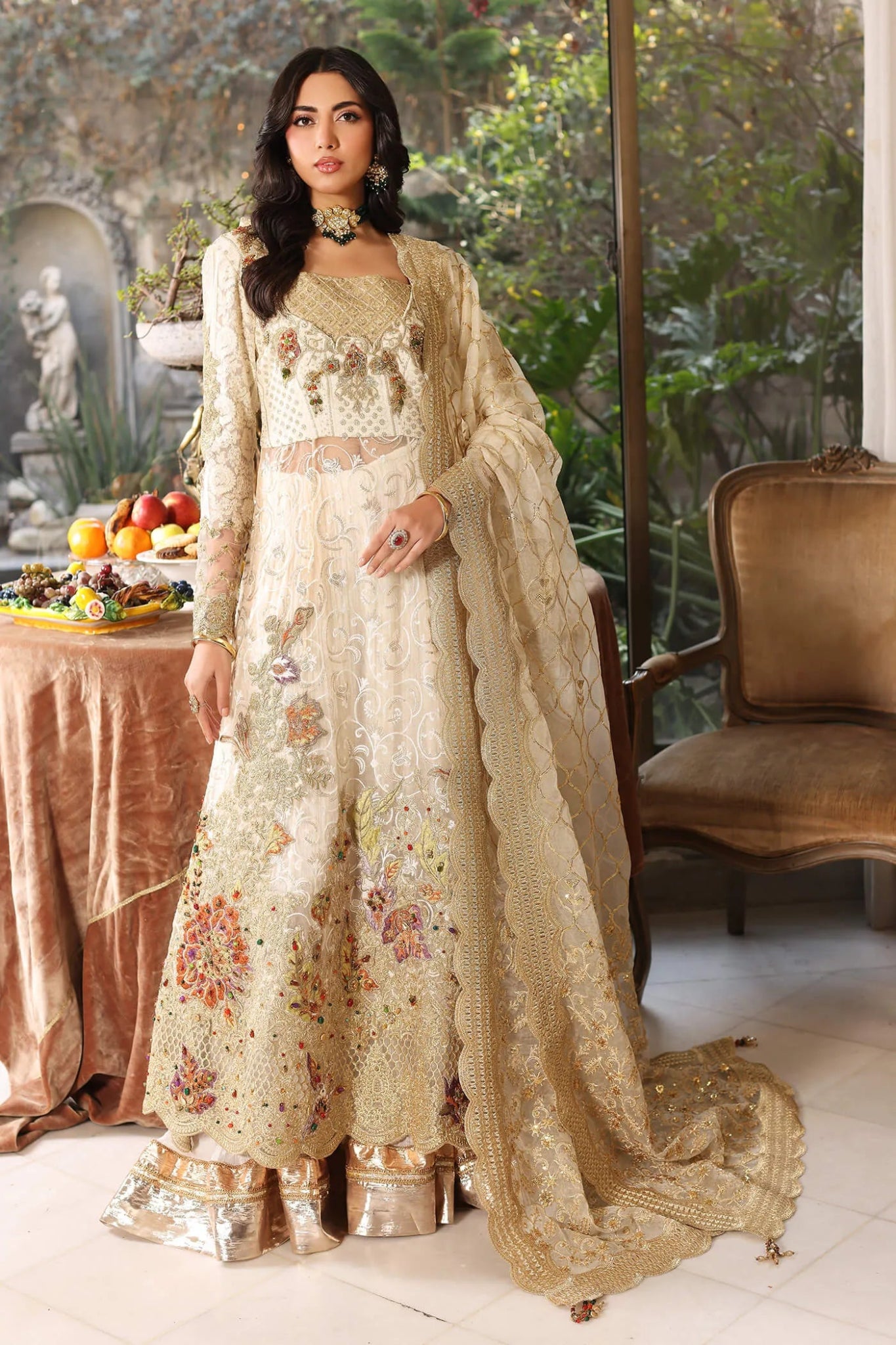 Model wearing a light ivory FLORAL MIST dress from Musferah Saad's ENCHANTE Eid collection '24, showcasing Pakistani clothes online in the UK.