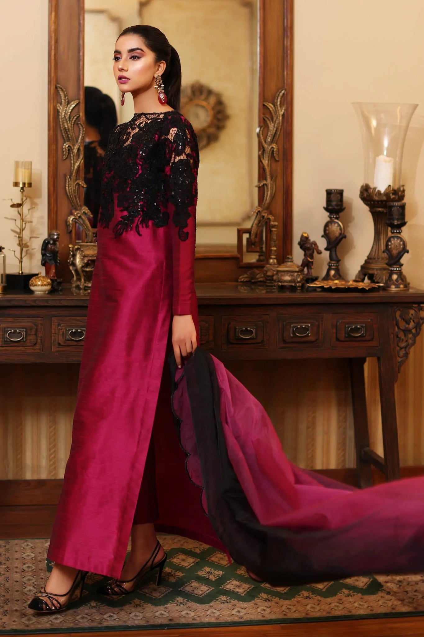 Model wearing a magenta ROYAL ONYX dress with black lace from Musferah Saad's ENCHANTE Eid collection '24, showcasing Pakistani clothes online in the UK.