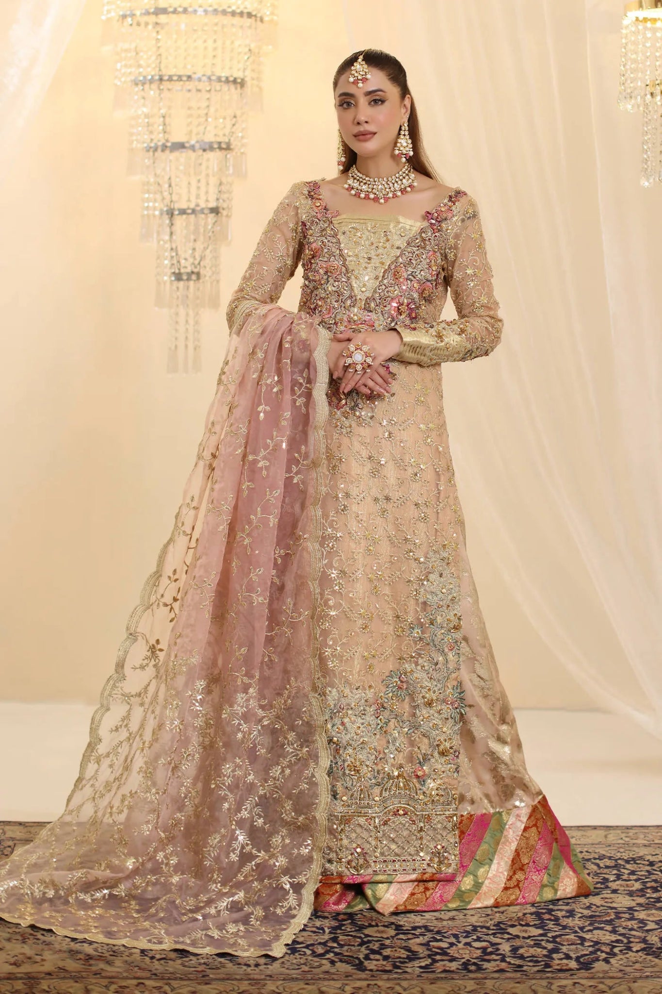 Model wearing Musferah Saad Coral Haze dress in peach and gold from the Ethereal Dream Formals collection, ideal for Pakistani wedding clothes online in the UK.