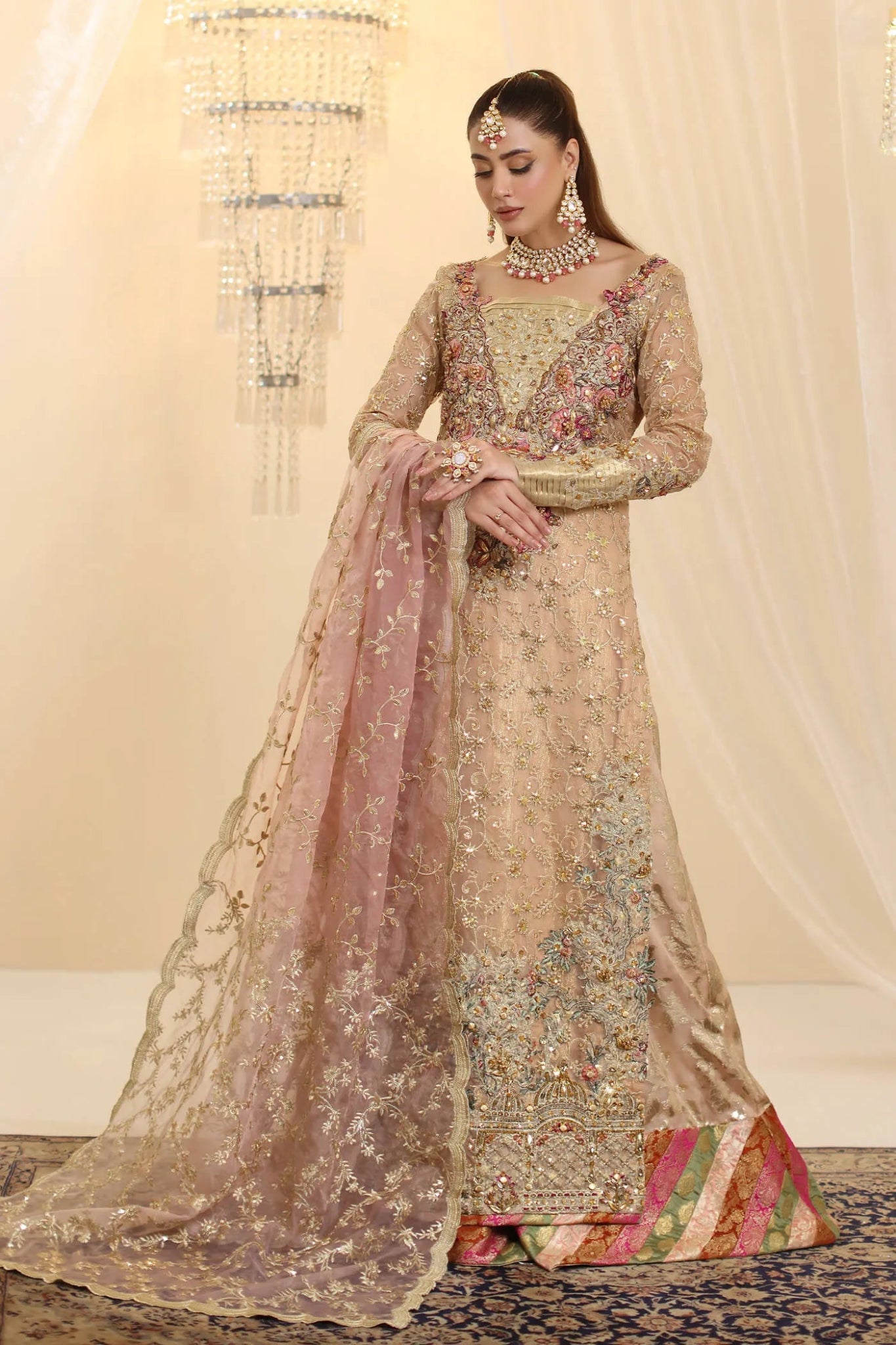 Model wearing Musferah Saad Coral Haze dress in peach and gold from the Ethereal Dream Formals collection, ideal for Pakistani wedding clothes online in the UK.