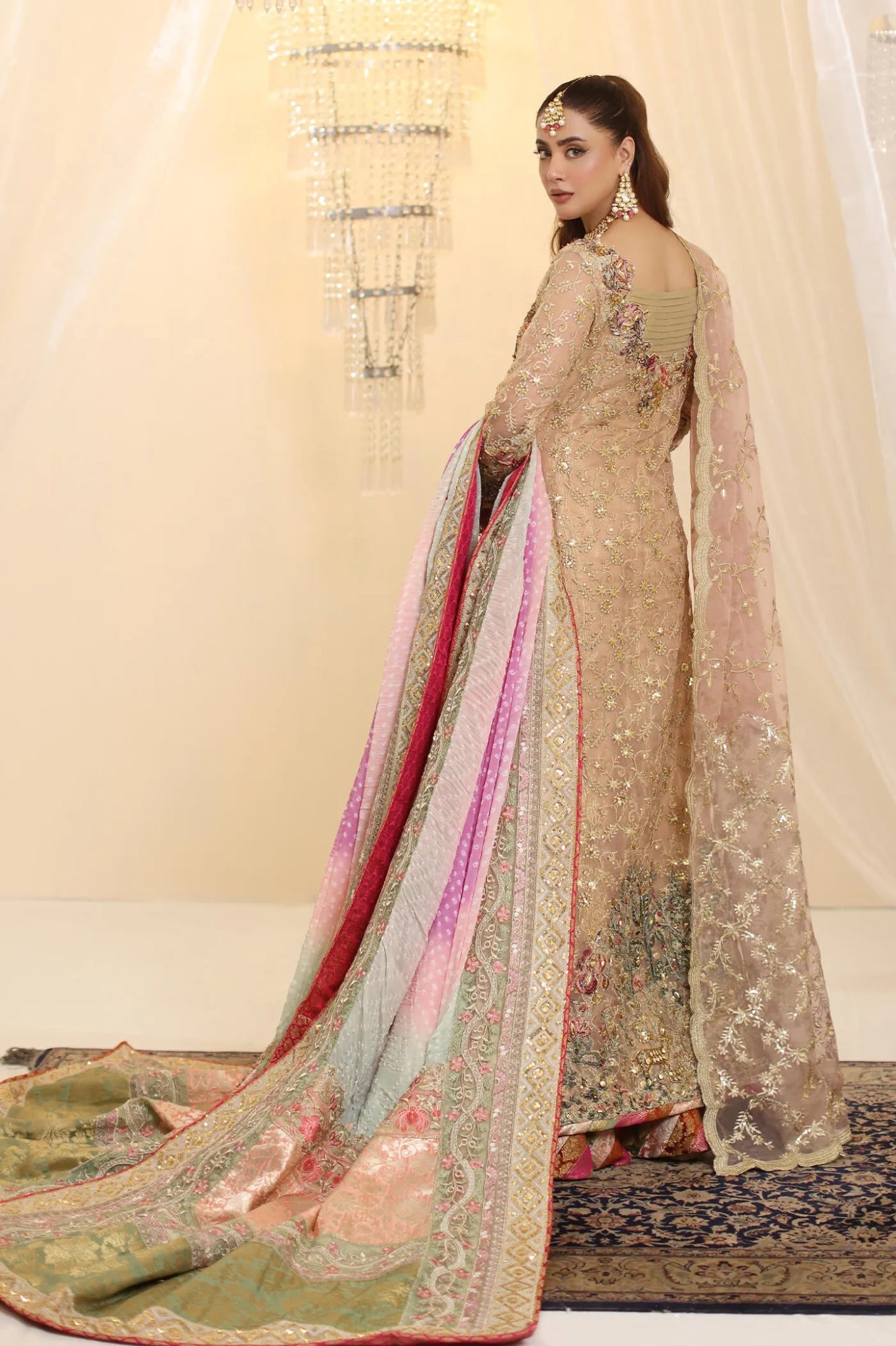 Model wearing Musferah Saad Coral Haze dress in peach and gold from the Ethereal Dream Formals collection, ideal for Pakistani wedding clothes online in the UK.