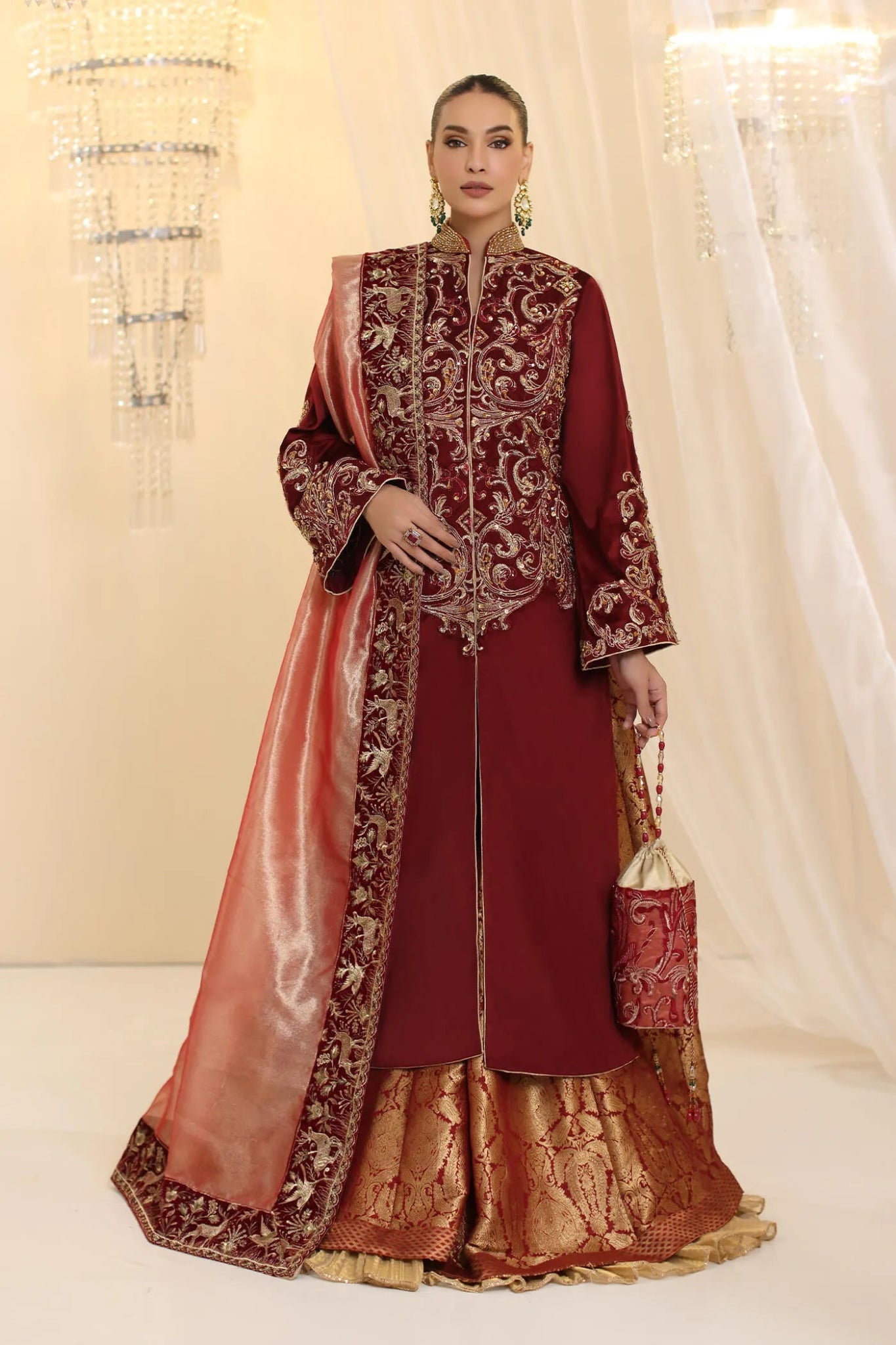 Model wearing Musferah Saad Grand Symphony dress in deep maroon from the Ethereal Dream Formals collection, ideal for Pakistani wedding clothes online in the UK.