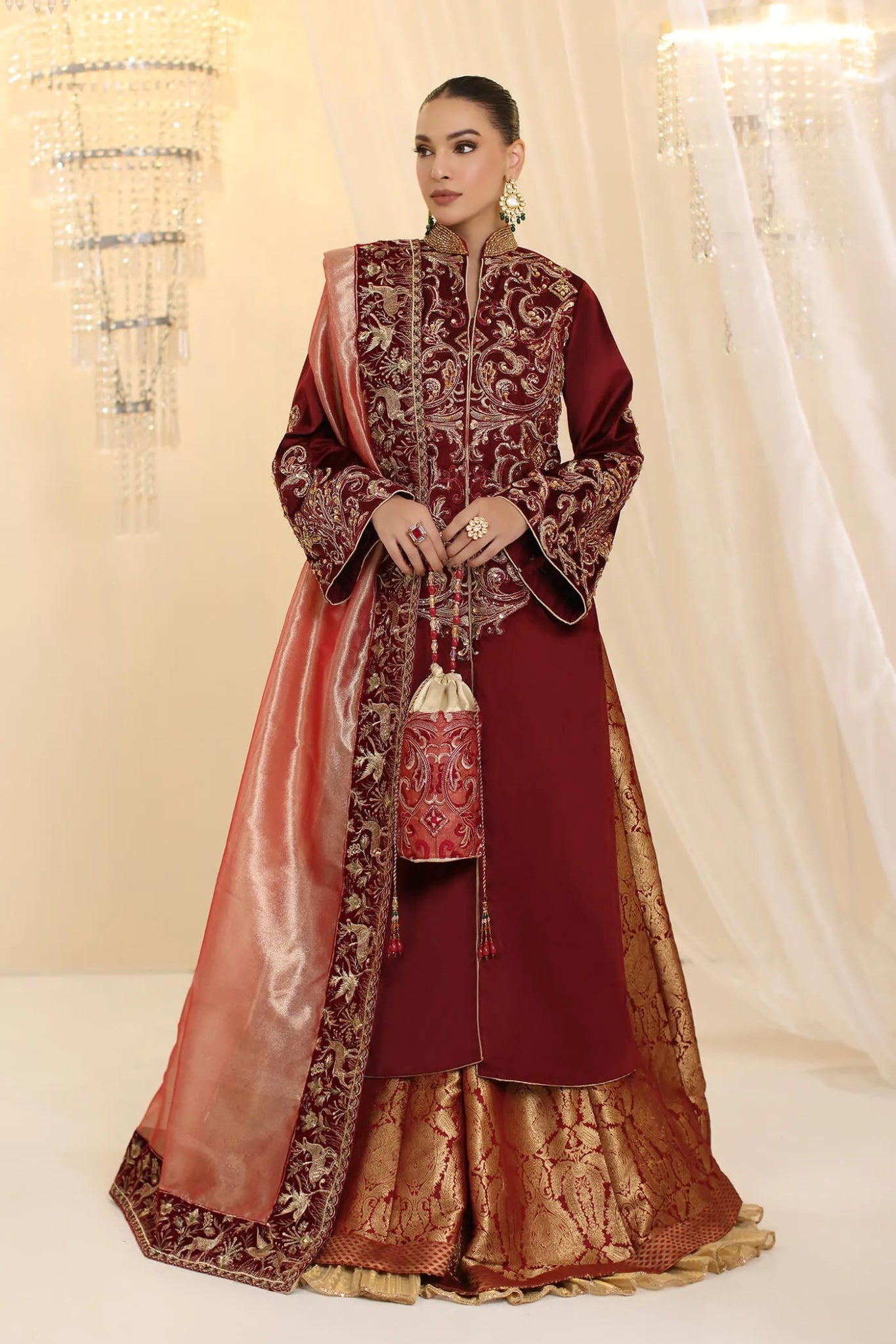 Model wearing Musferah Saad Grand Symphony dress in deep maroon from the Ethereal Dream Formals collection, ideal for Pakistani wedding clothes online in the UK.