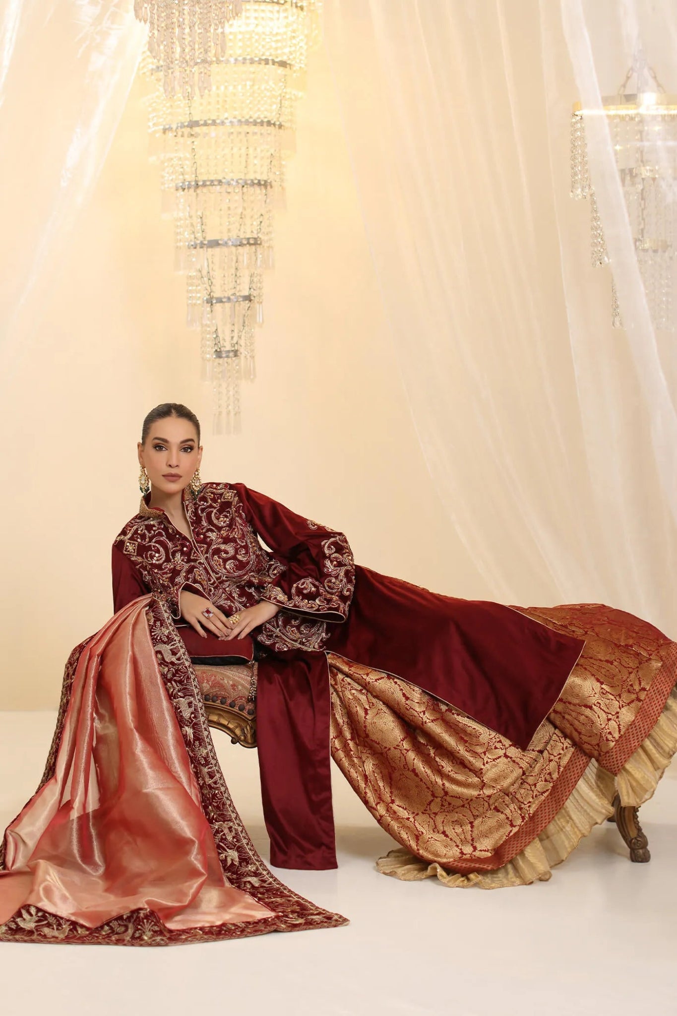 Model wearing Musferah Saad Grand Symphony dress in deep maroon from the Ethereal Dream Formals collection, ideal for Pakistani wedding clothes online in the UK.