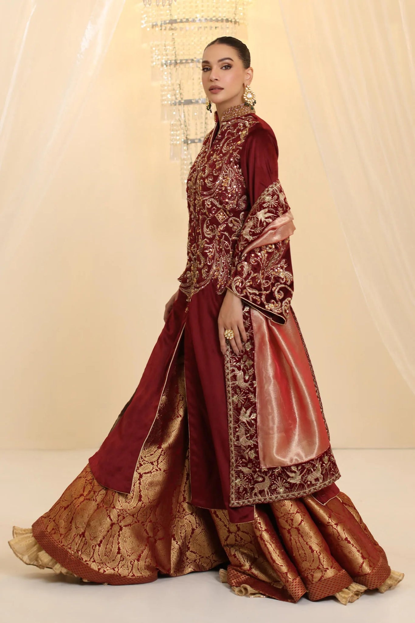 Model wearing Musferah Saad Grand Symphony dress in deep maroon from the Ethereal Dream Formals collection, ideal for Pakistani wedding clothes online in the UK.