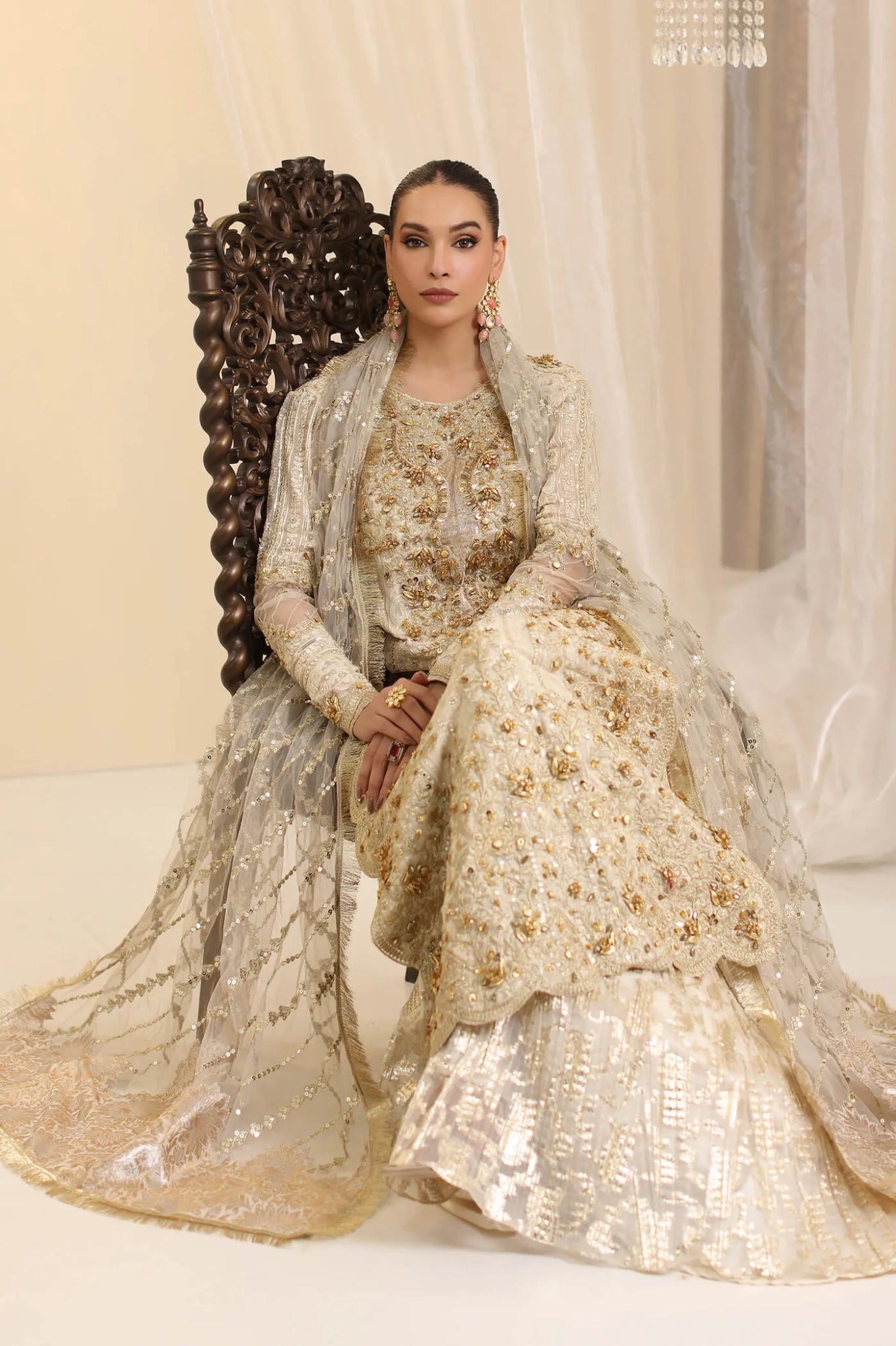 Model wearing Musferah Saad Ivory Empress dress in ivory from the Ethereal Dream Formals collection, ideal for Pakistani wedding clothes online in the UK.