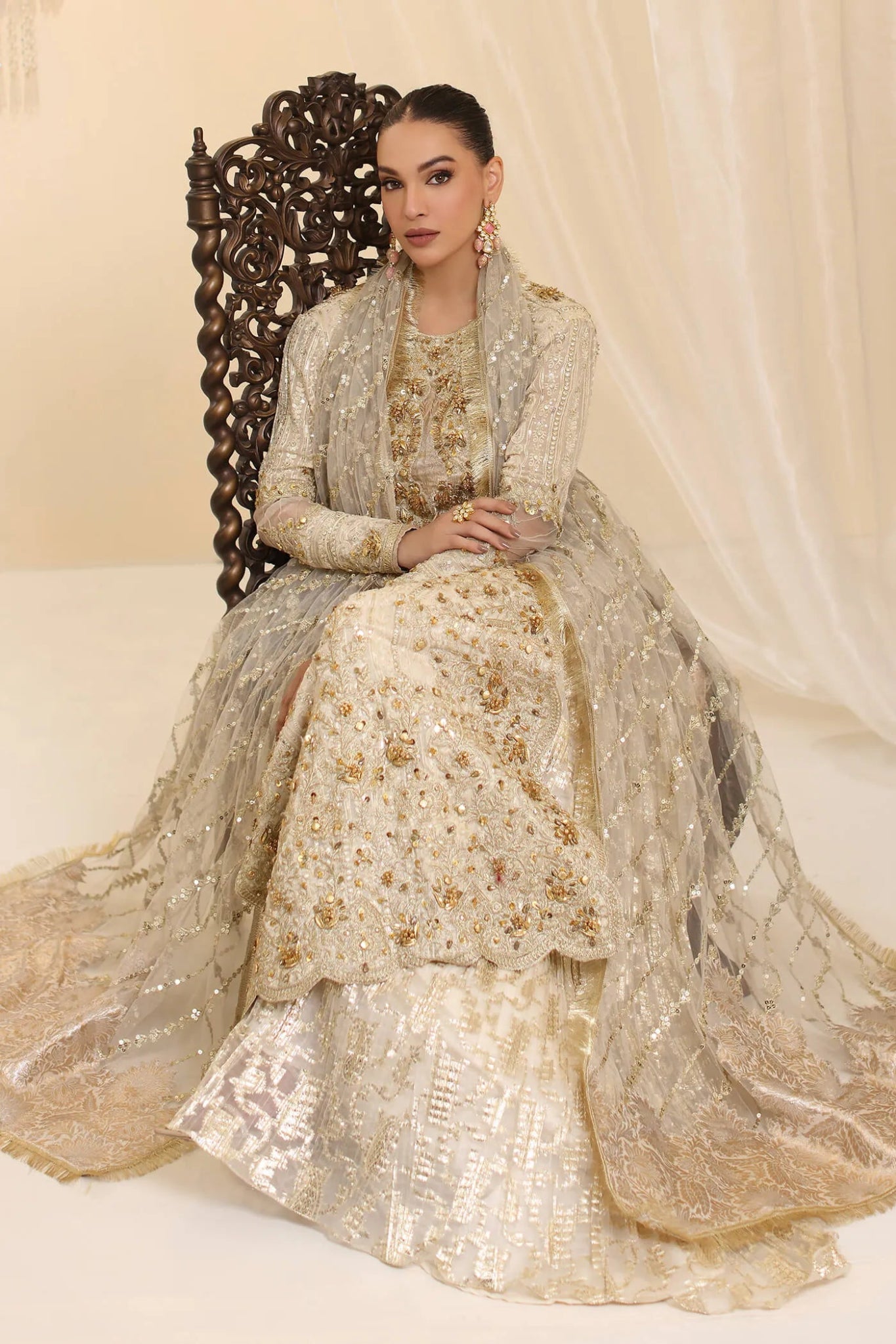 Model wearing Musferah Saad Ivory Empress dress in ivory from the Ethereal Dream Formals collection, ideal for Pakistani wedding clothes online in the UK.