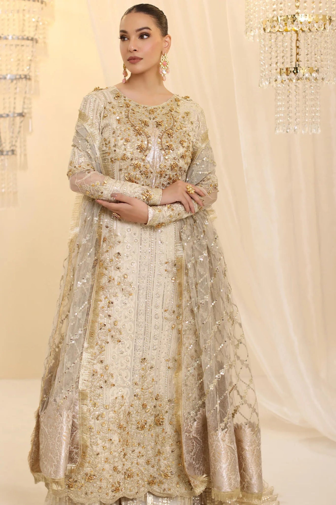 Model wearing Musferah Saad Ivory Empress dress in ivory from the Ethereal Dream Formals collection, ideal for Pakistani wedding clothes online in the UK.