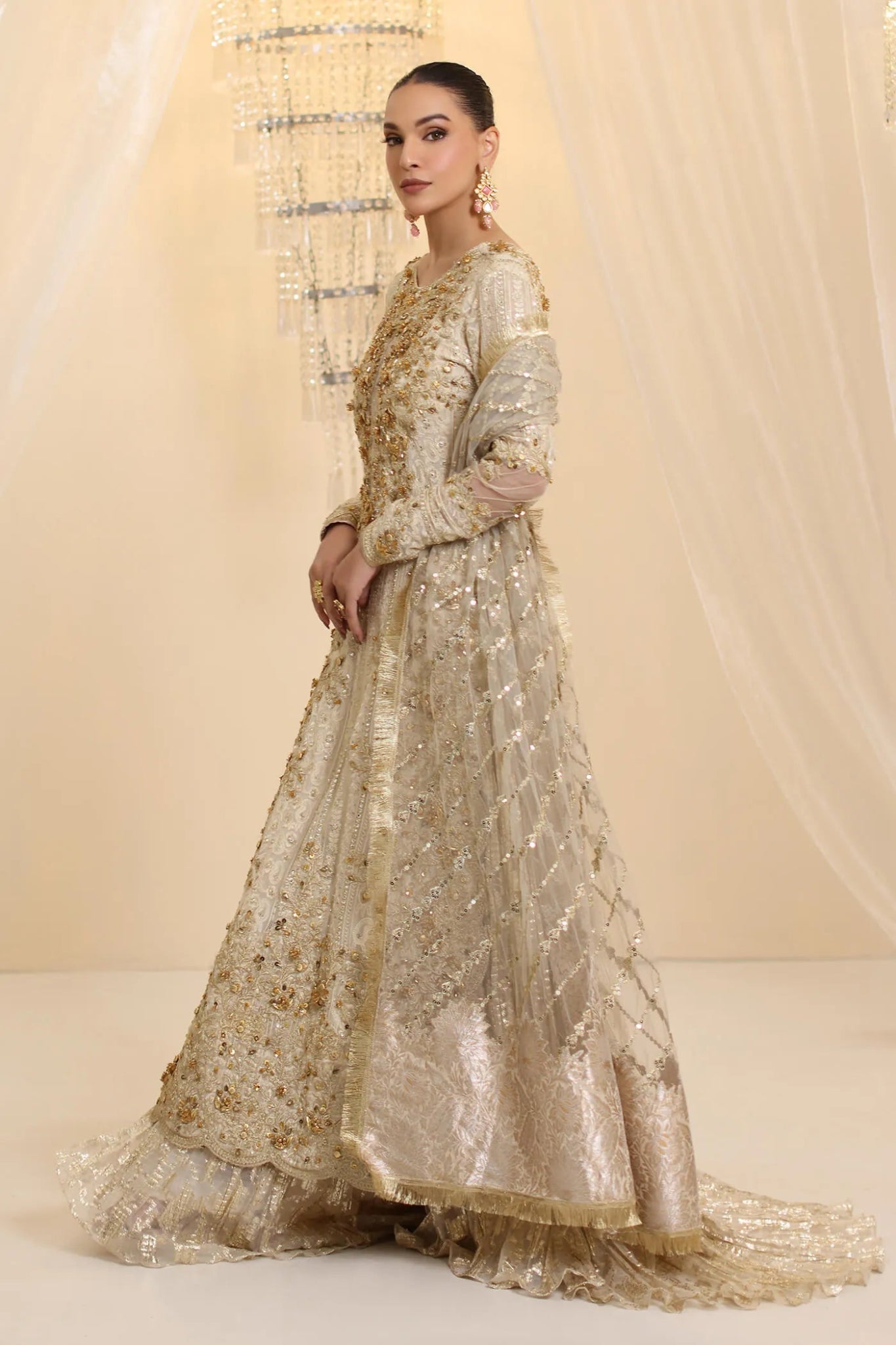 Model wearing Musferah Saad Ivory Empress dress in ivory from the Ethereal Dream Formals collection, ideal for Pakistani wedding clothes online in the UK.