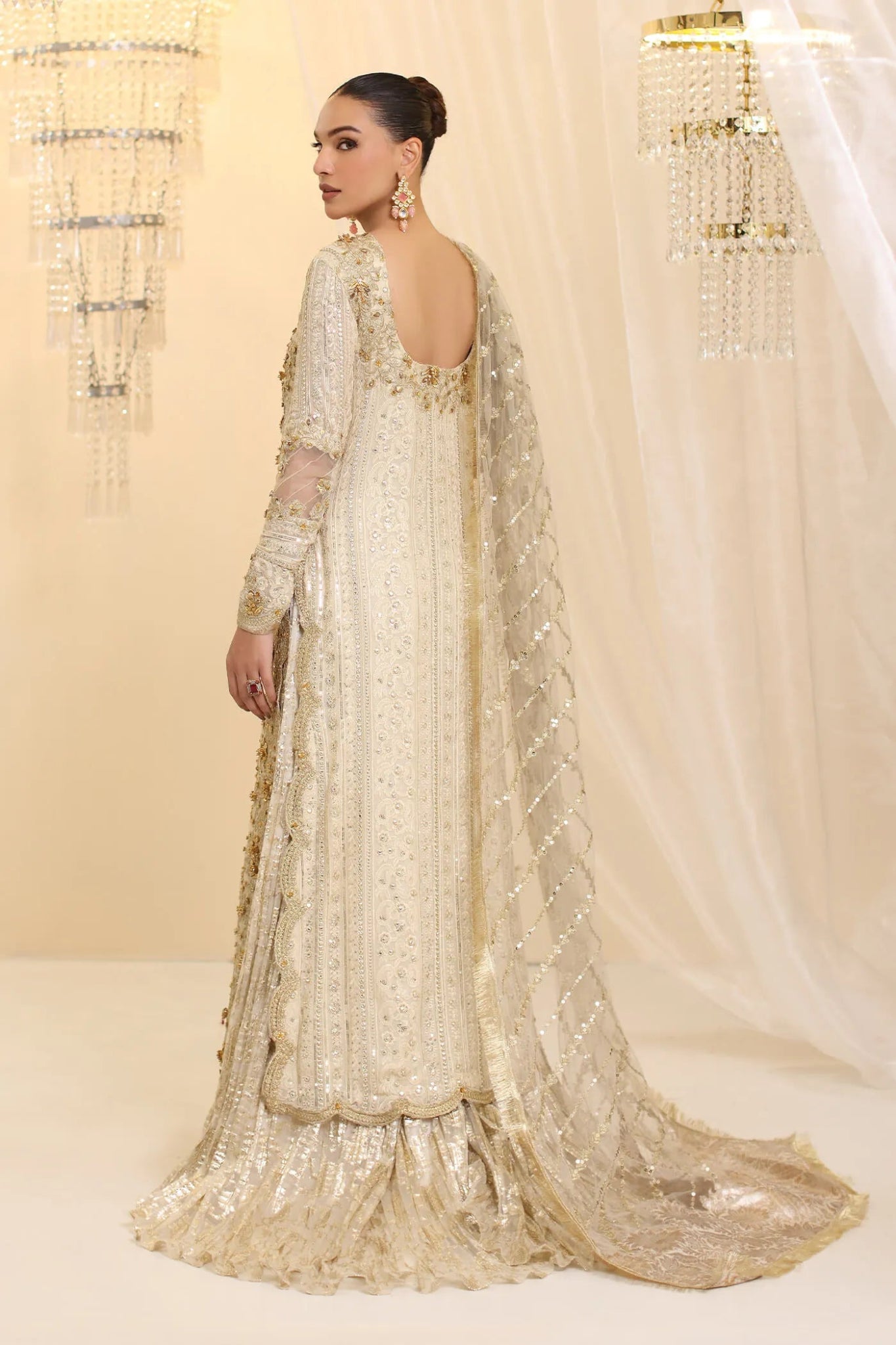 Model wearing Musferah Saad Ivory Empress dress in ivory from the Ethereal Dream Formals collection, ideal for Pakistani wedding clothes online in the UK.