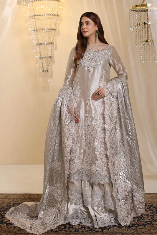 Model wearing Musferah Saad Lunar Radiance dress in silver from the Ethereal Dream Formals collection, perfect for Pakistani wedding clothes online in the UK.