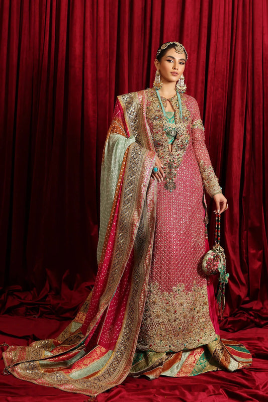 Model in Musferah Saad Serene Light, traditional shocking pink Pakistani bridal dress, UK.