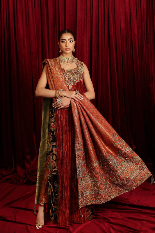 Model in Musferah Saad Sunstone Symphony, a rust Pakistani bridal dress in the UK.