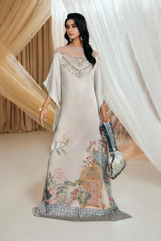 Model wearing Faiza Saqlain's Aqua Elegance dress from the Musferah Saad Mystere Eid Collection '24. An ethereal ice - blue kaftan with delicate embellishments and colorful floral motifs, perfect for those seeking Pakistani designer clothes in the UK.