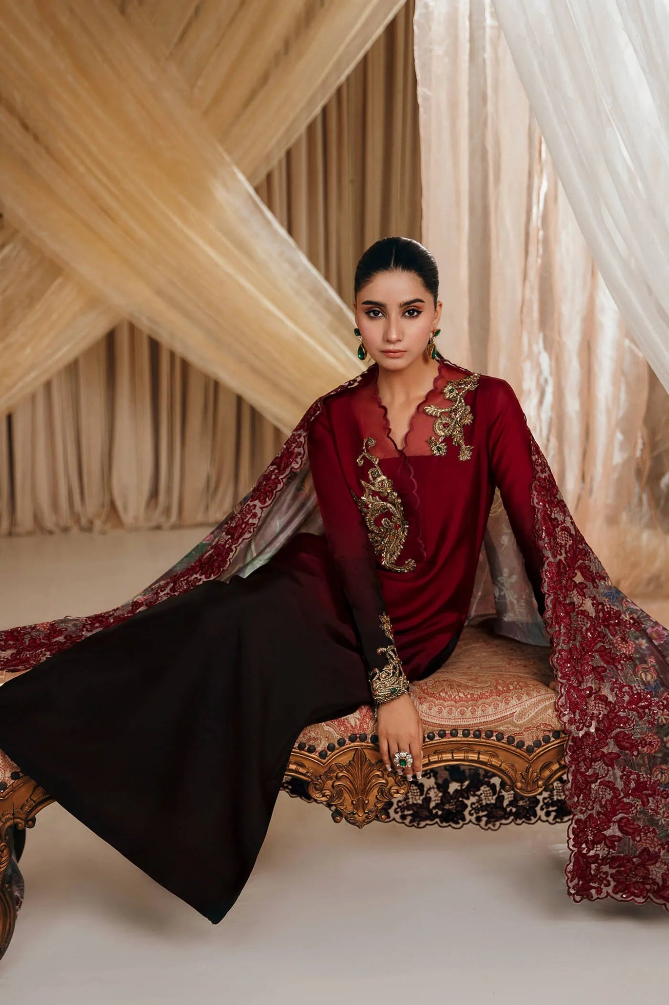 Model wearing a crimson and black CRIMSON ROSE dress from Musferah Saad's MYSTERE Eid collection '24, showcasing Pakistani clothes online in the UK.