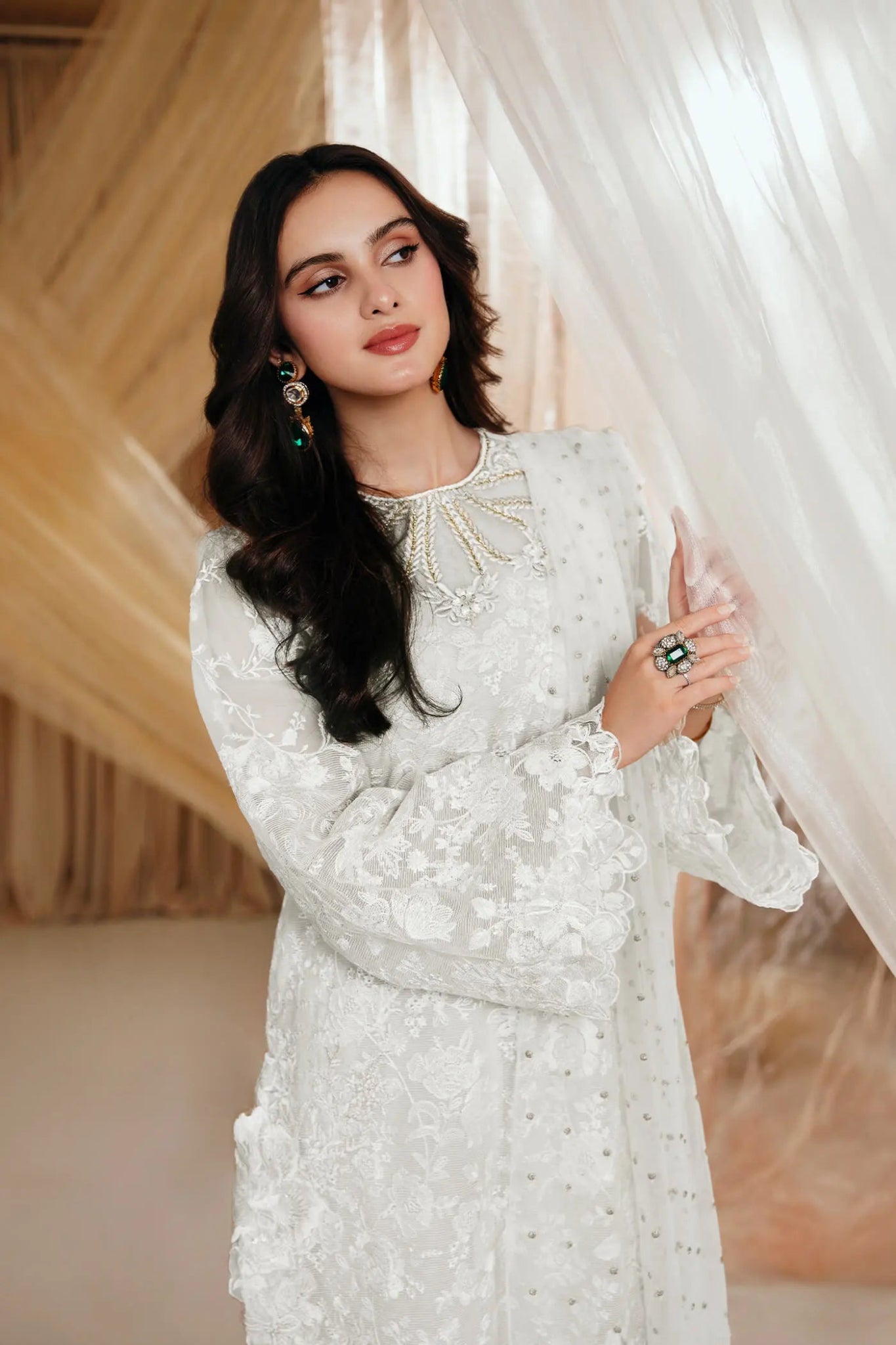 Model wearing an off - white DIVINE WHISPER dress from Musferah Saad's MYSTERE Eid collection '24, showcasing Pakistani clothes online in the UK.