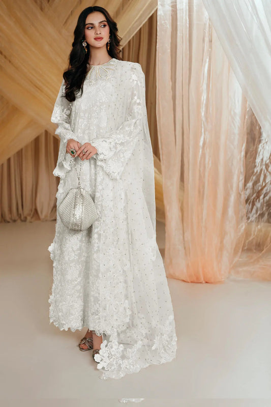 Model wearing an off - white DIVINE WHISPER dress from Musferah Saad's MYSTERE Eid collection '24, showcasing Pakistani clothes online in the UK.