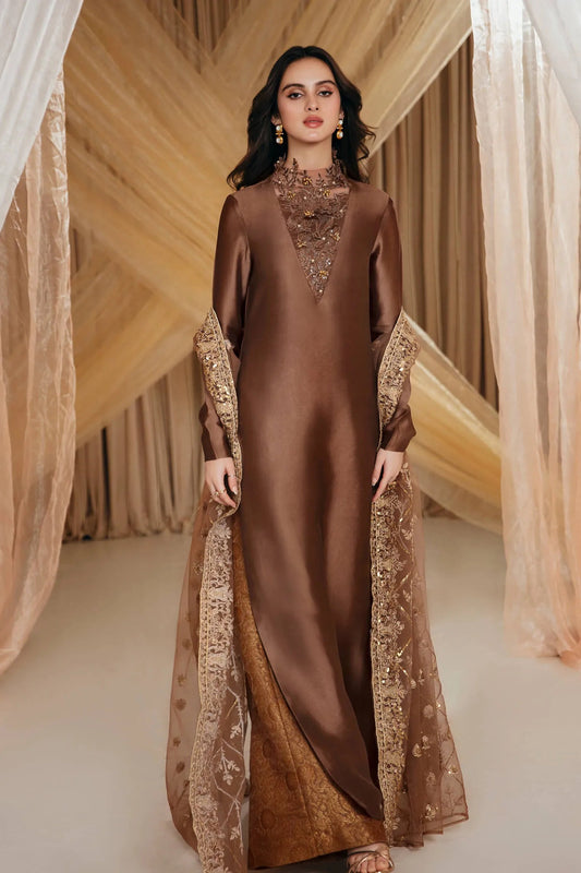 Model wearing a brown ETHEREAL GODDESS dress from Musferah Saad's MYSTERE Eid collection '24, showcasing Pakistani clothes online in the UK.