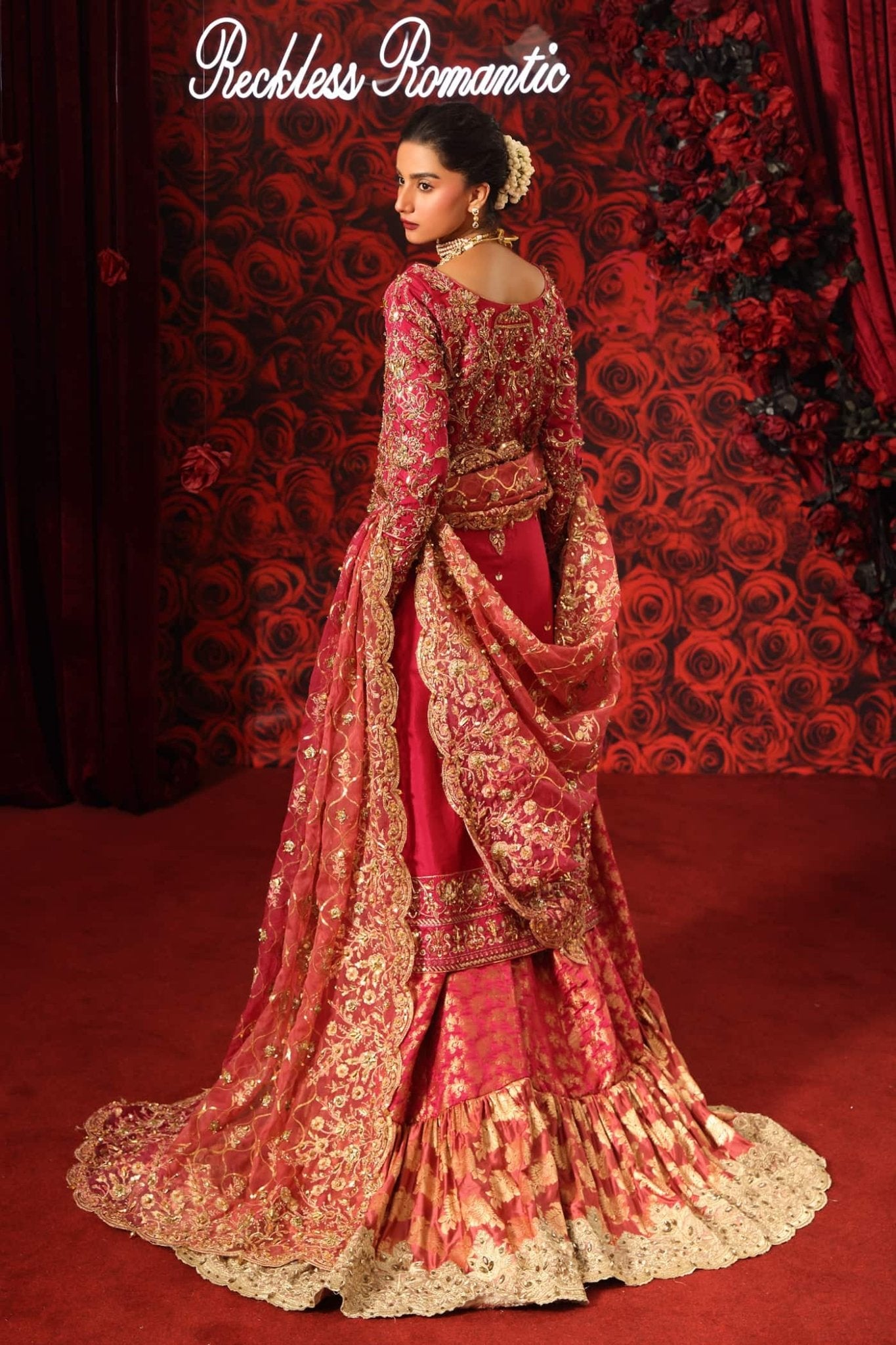 Model wearing Crimson Queen from Musferah Saad's Reckless Romantic in luxurious deep red tones. Pakistani clothes online in UK at Signature Labels