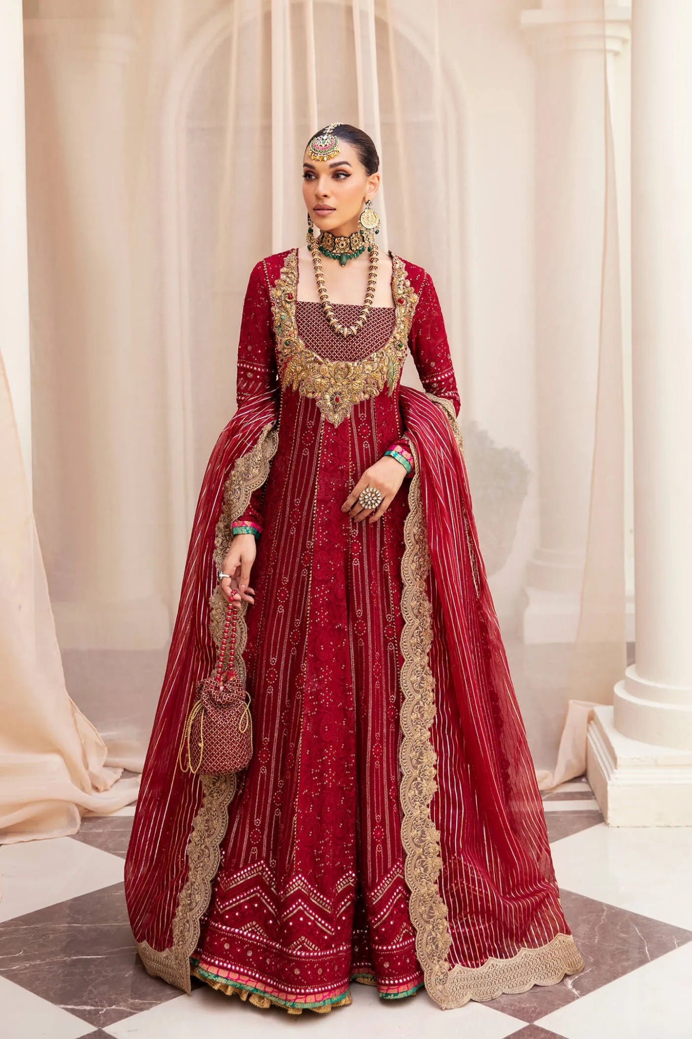 Model wearing a luxurious deep red SCARLET ELEGANCE dress from Musferah Saad's Symphony '23 collection, highlighting Pakistani clothes online in the UK.