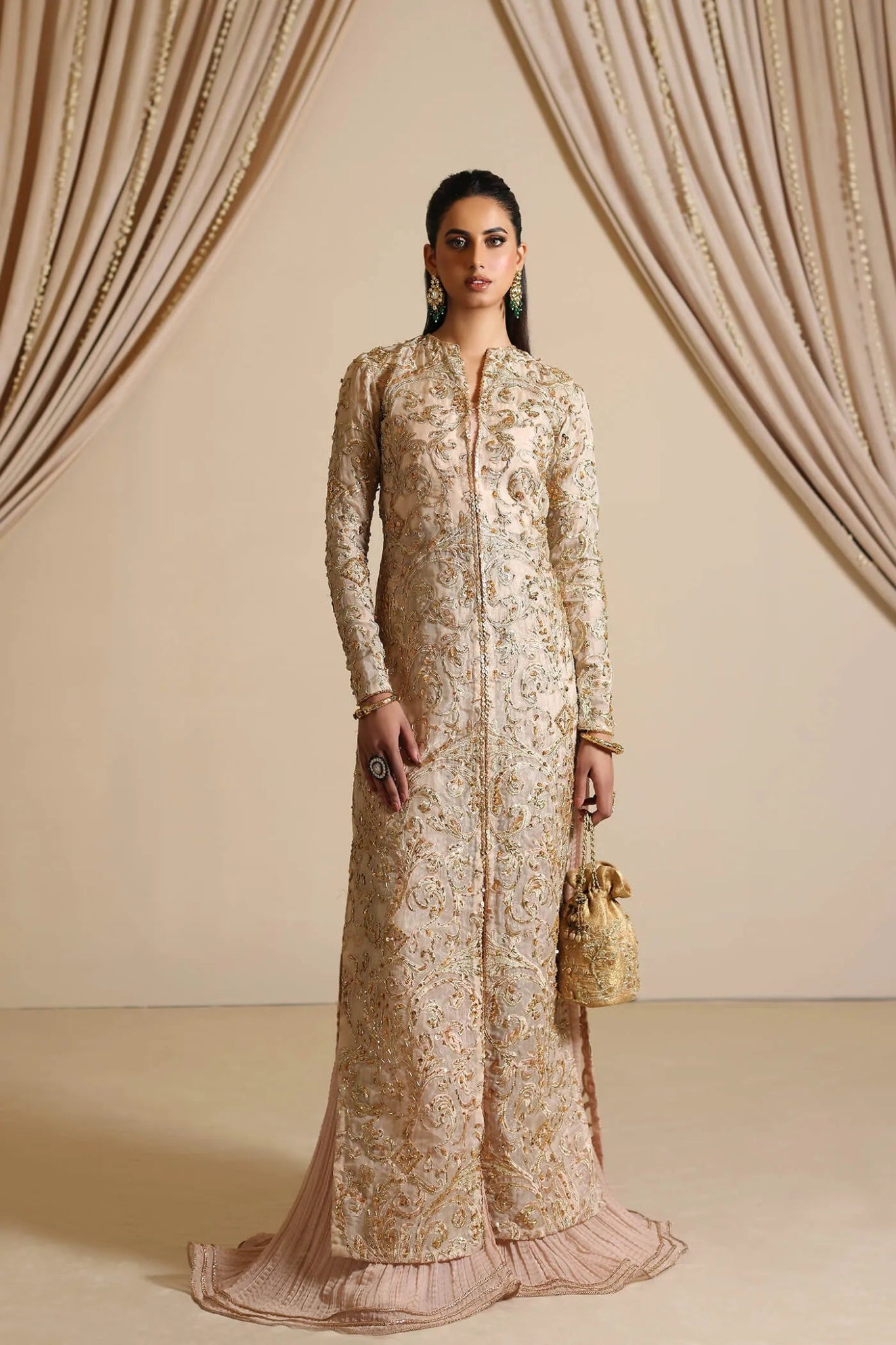 Model wearing Musferah Saad Golden Mirage, an elegant Pakistani bridal dress in UK.