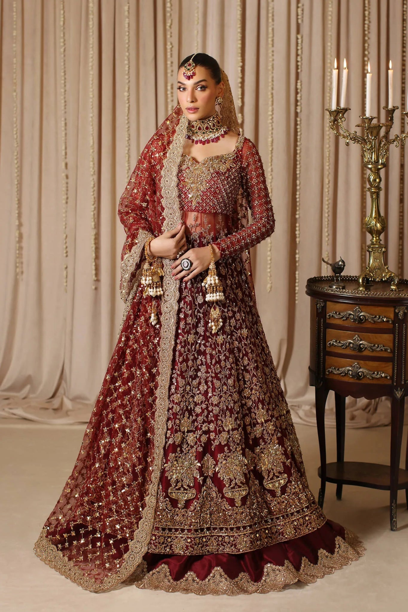 Model wearing a maroon MAHARANI dress from Musferah Saad's The Modern Maharani '23 collection, showcasing Pakistani clothes online in the UK.