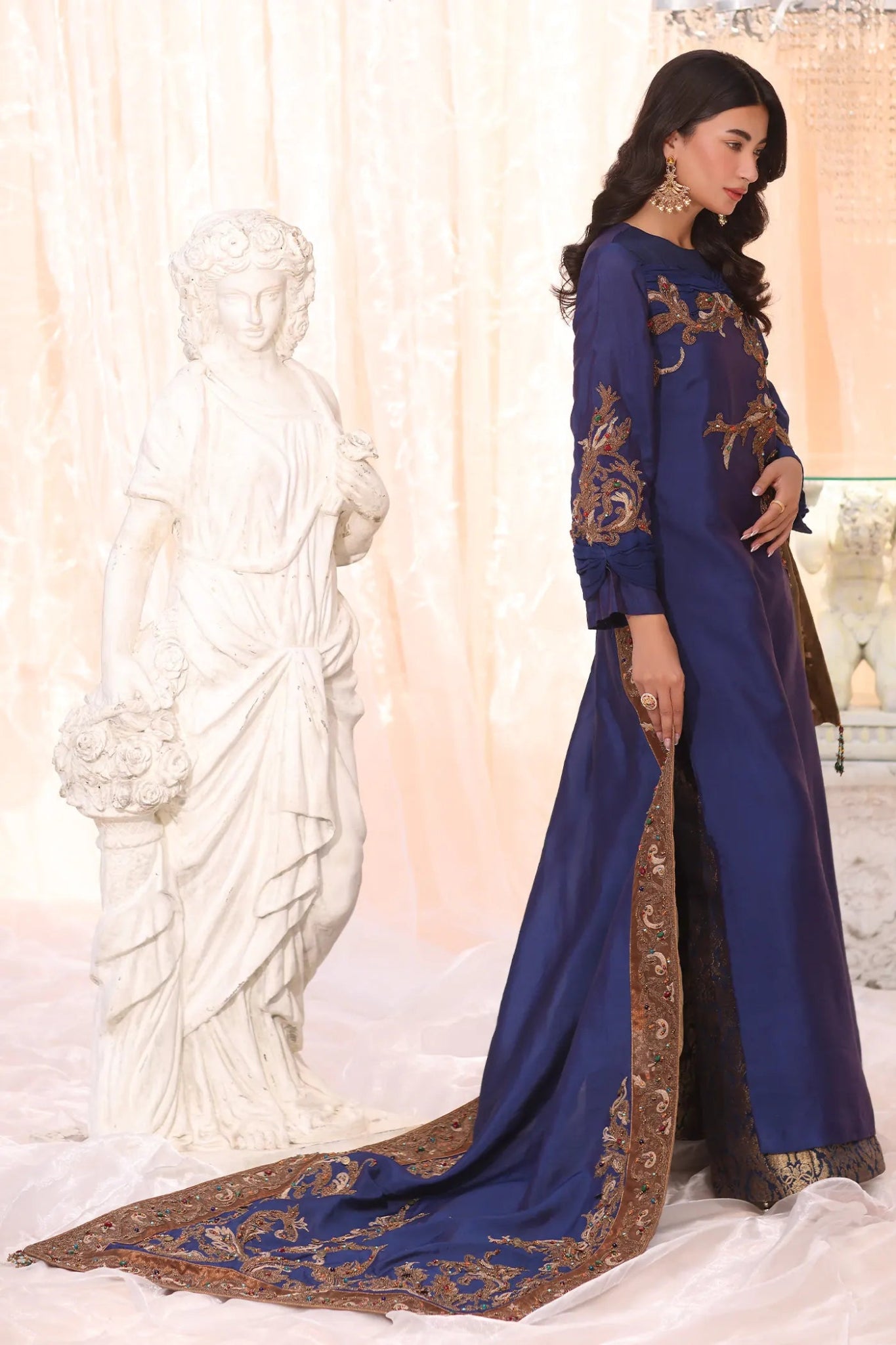 Model wearing Sapphire Empress from Musferah Saad's The Serenade collection, featuring elegant blue hues. Pakistani clothes online in UK at Signature Labels.