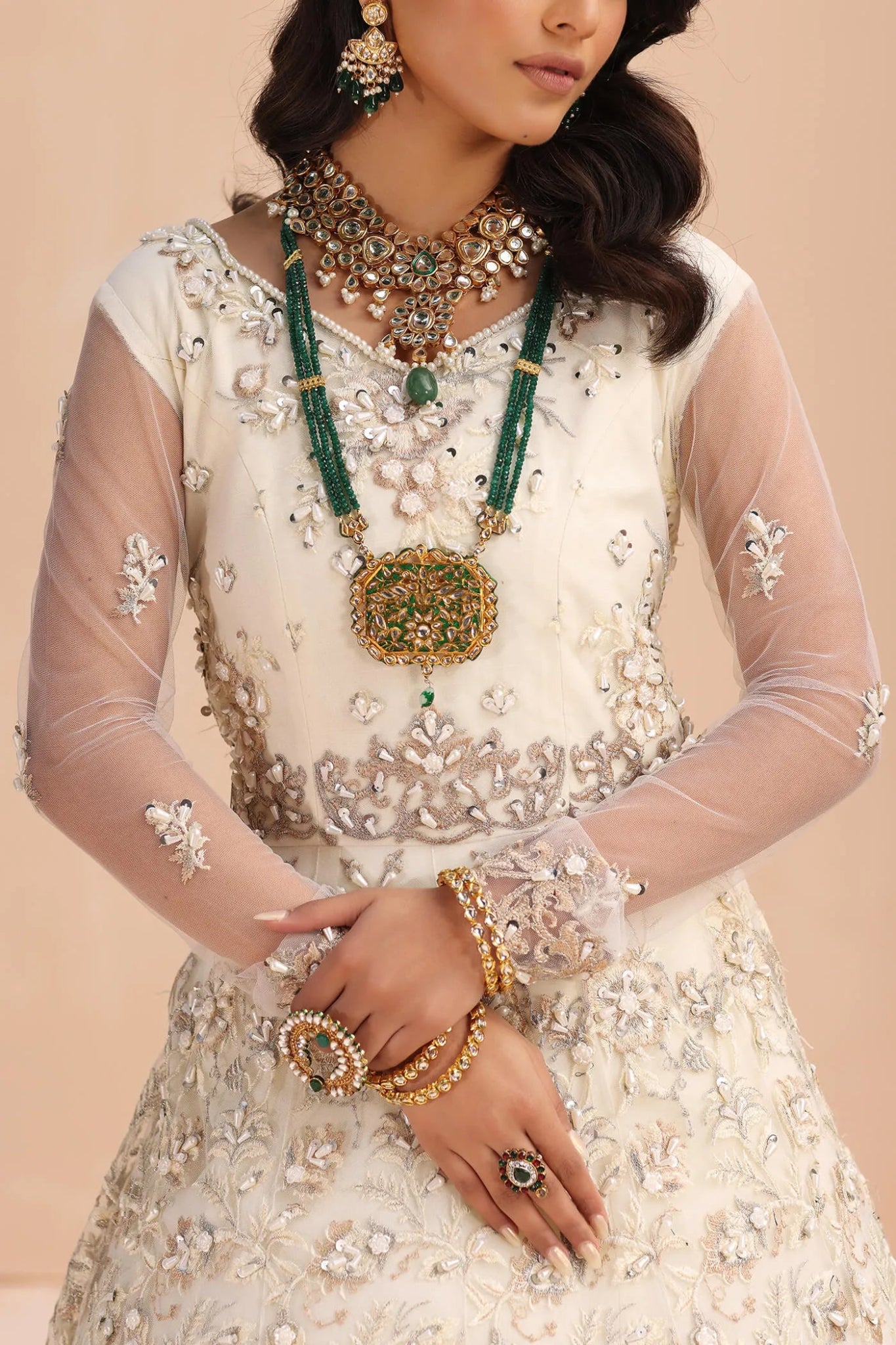 Model wearing an ivory IVORY ELEGANCE dress from Musferah Saad's Wedding Secret Treasure collection, showcasing Pakistani clothes online in the UK.