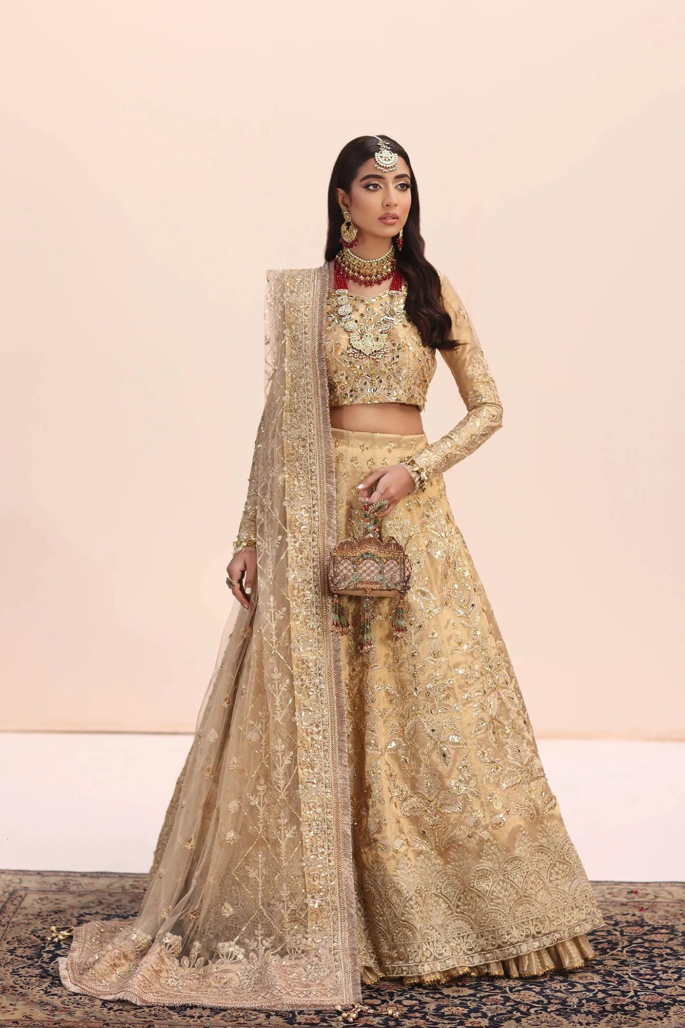 Model in Musferah Saad Luminous Dream gold Pakistani wedding dress, UK.