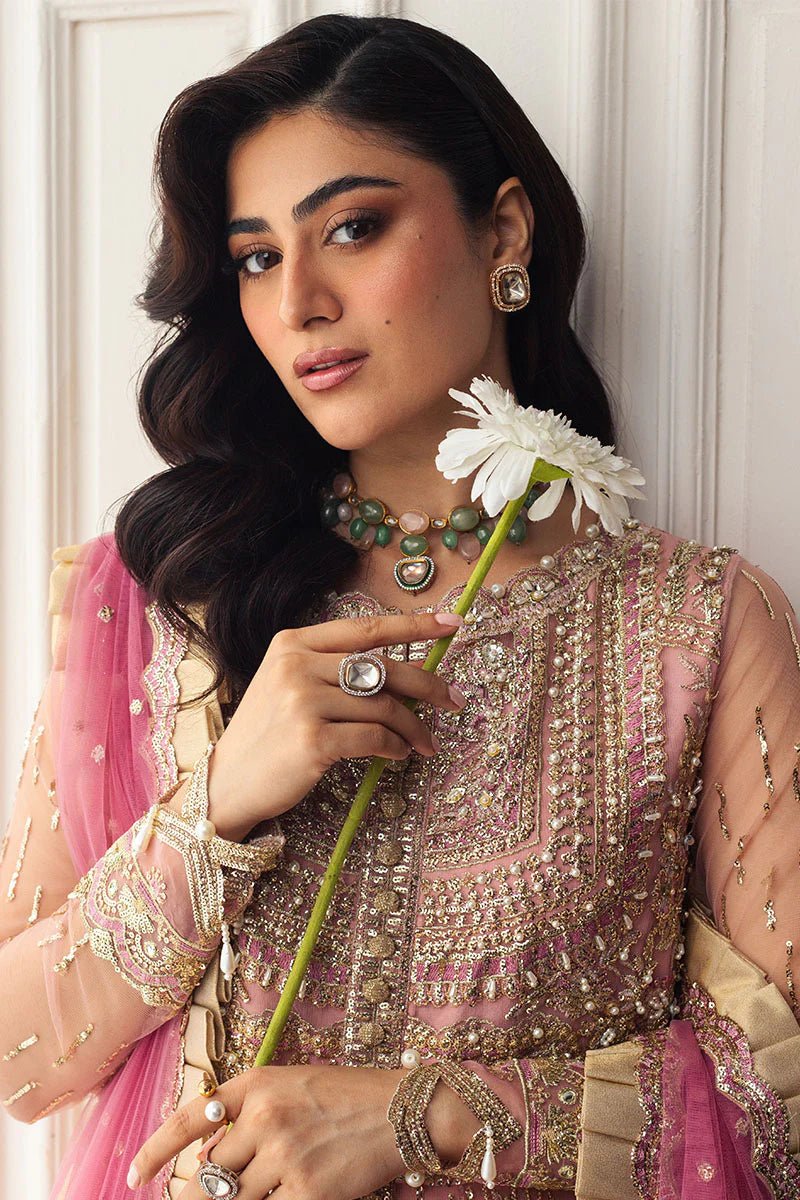 Model wearing a blush pink embellished formal wedding dress, "Amaranth," from Mushq. Pakistani wedding clothes online in the UK.