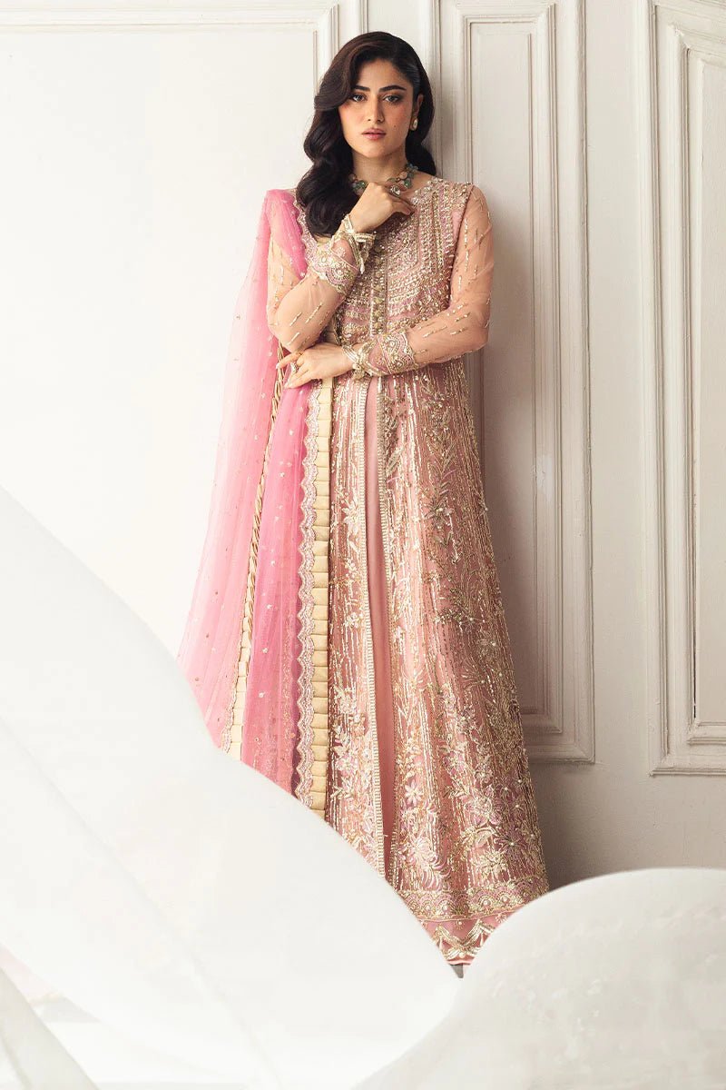 Model wearing a blush pink embellished formal wedding dress, "Amaranth," from Mushq. Pakistani wedding clothes online in the UK.