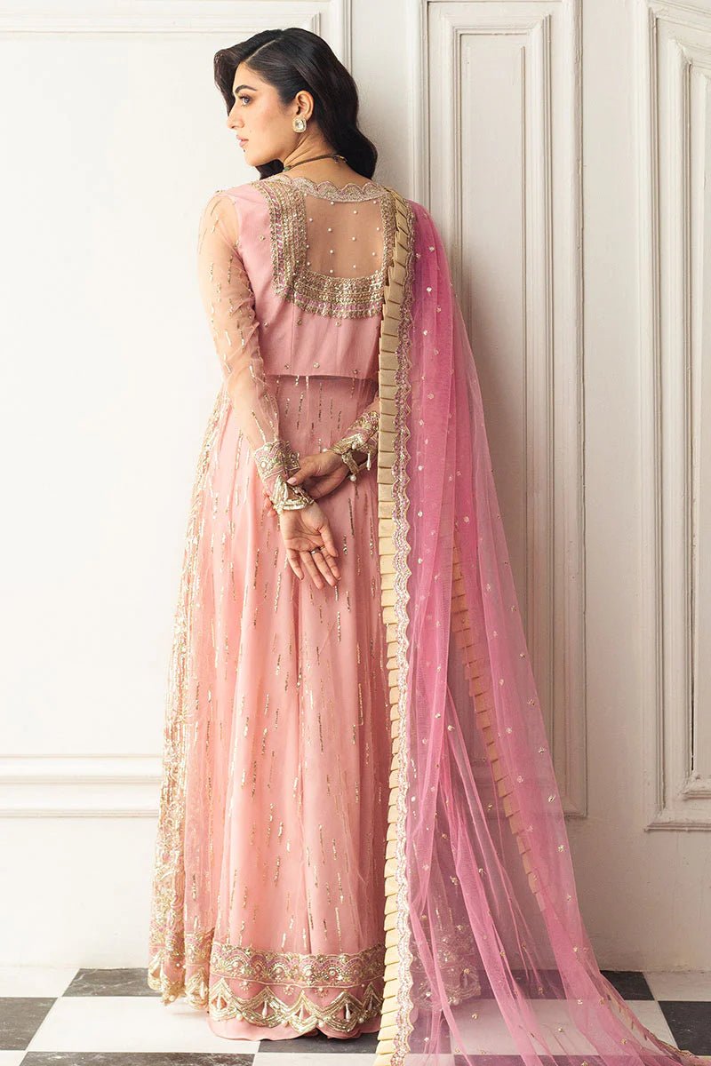 Model wearing a blush pink embellished formal wedding dress, "Amaranth," from Mushq. Pakistani wedding clothes online in the UK.