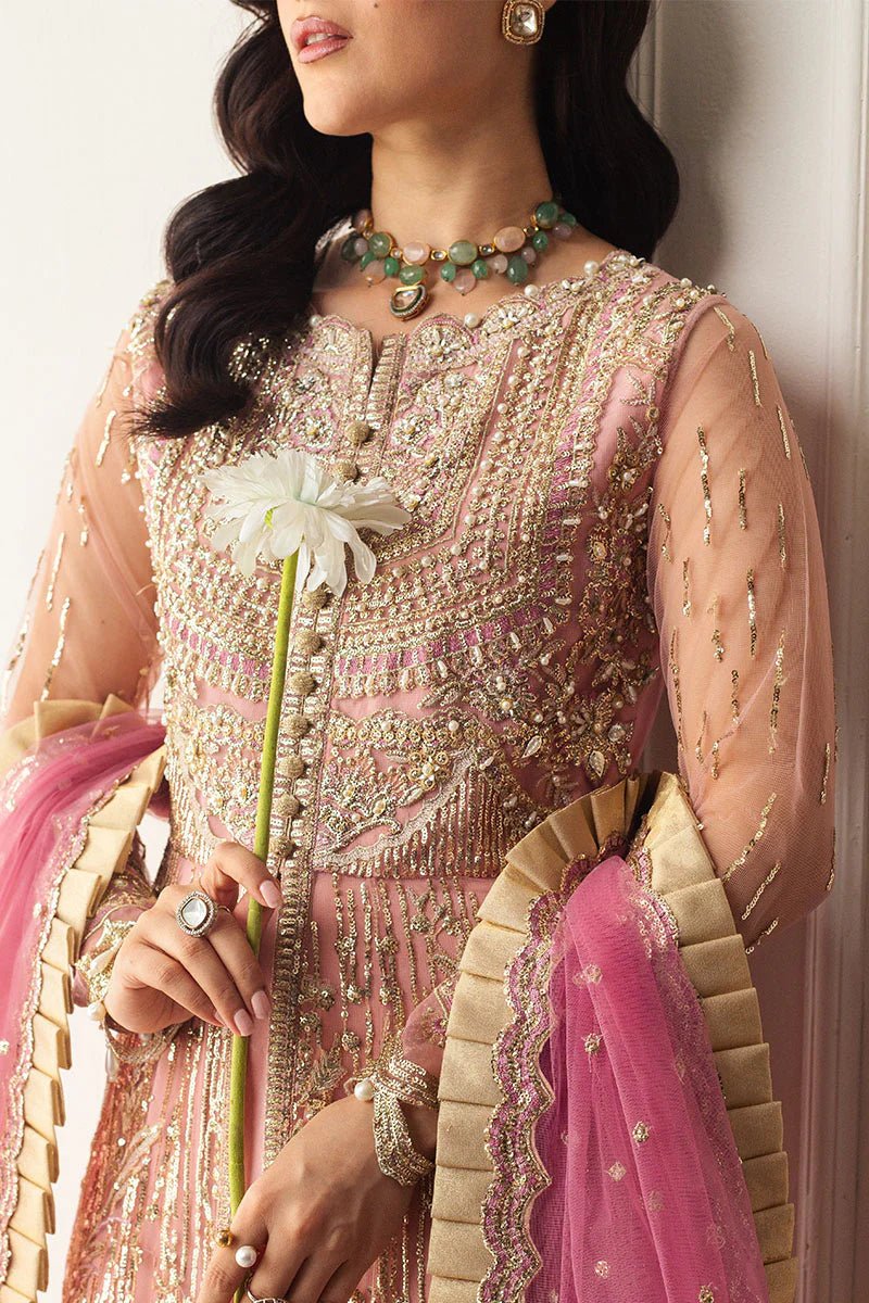 Model wearing a blush pink embellished formal wedding dress, "Amaranth," from Mushq. Pakistani wedding clothes online in the UK.