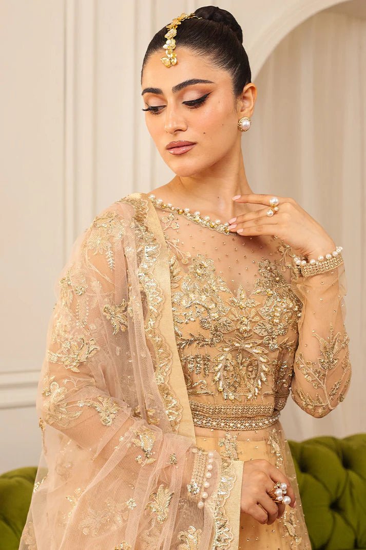 Model wearing a soft chamois wedding formal dress from Mushq, featuring intricate embellishments. Pakistani wedding clothes online in the UK.