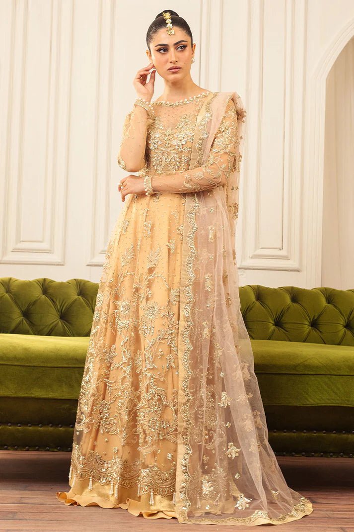 Model wearing a soft chamois wedding formal dress from Mushq, featuring intricate embellishments. Pakistani wedding clothes online in the UK.